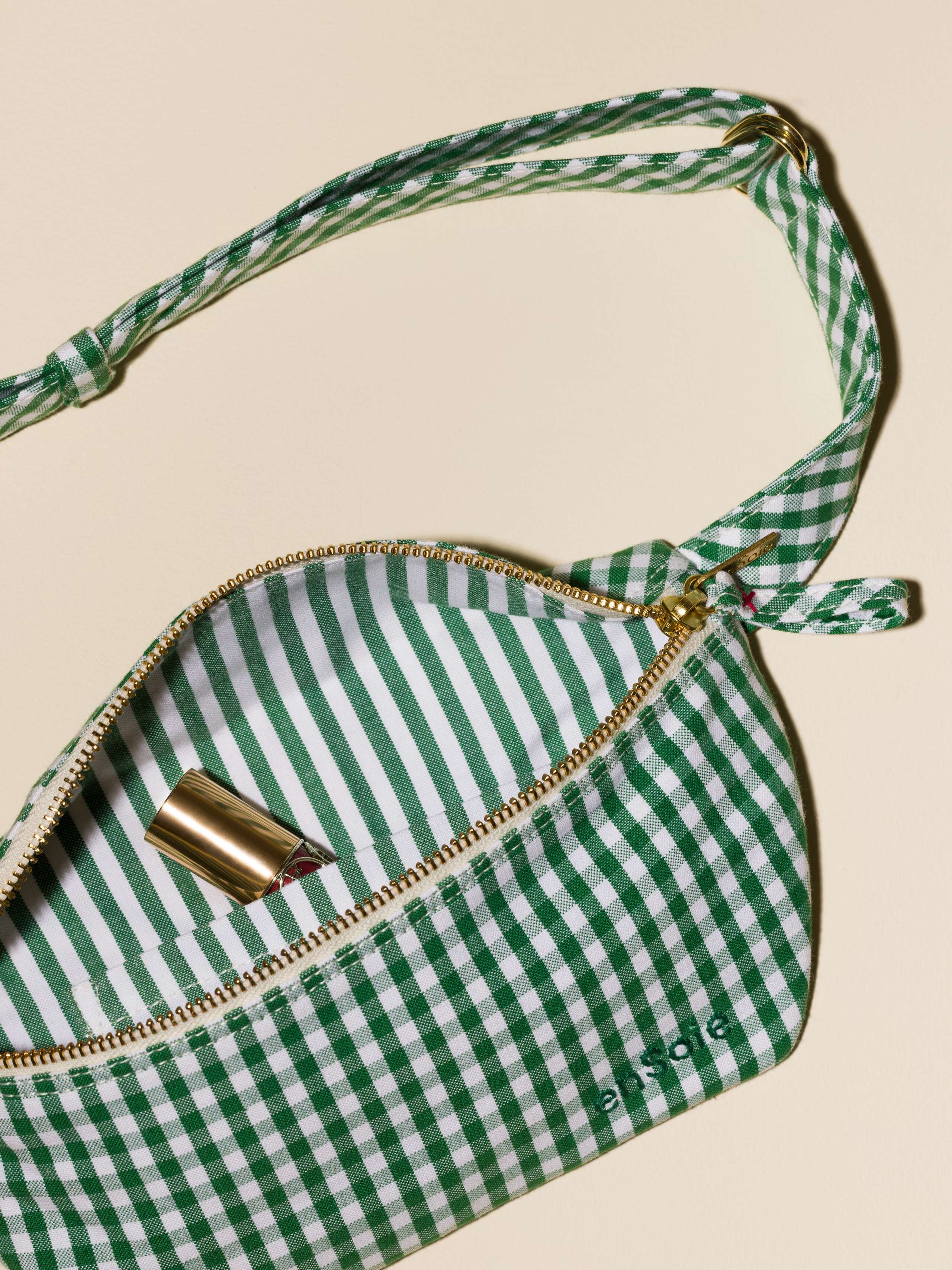 Picture of a cute cotton hip bag featuring a green vichy check pattern and a striped pattern