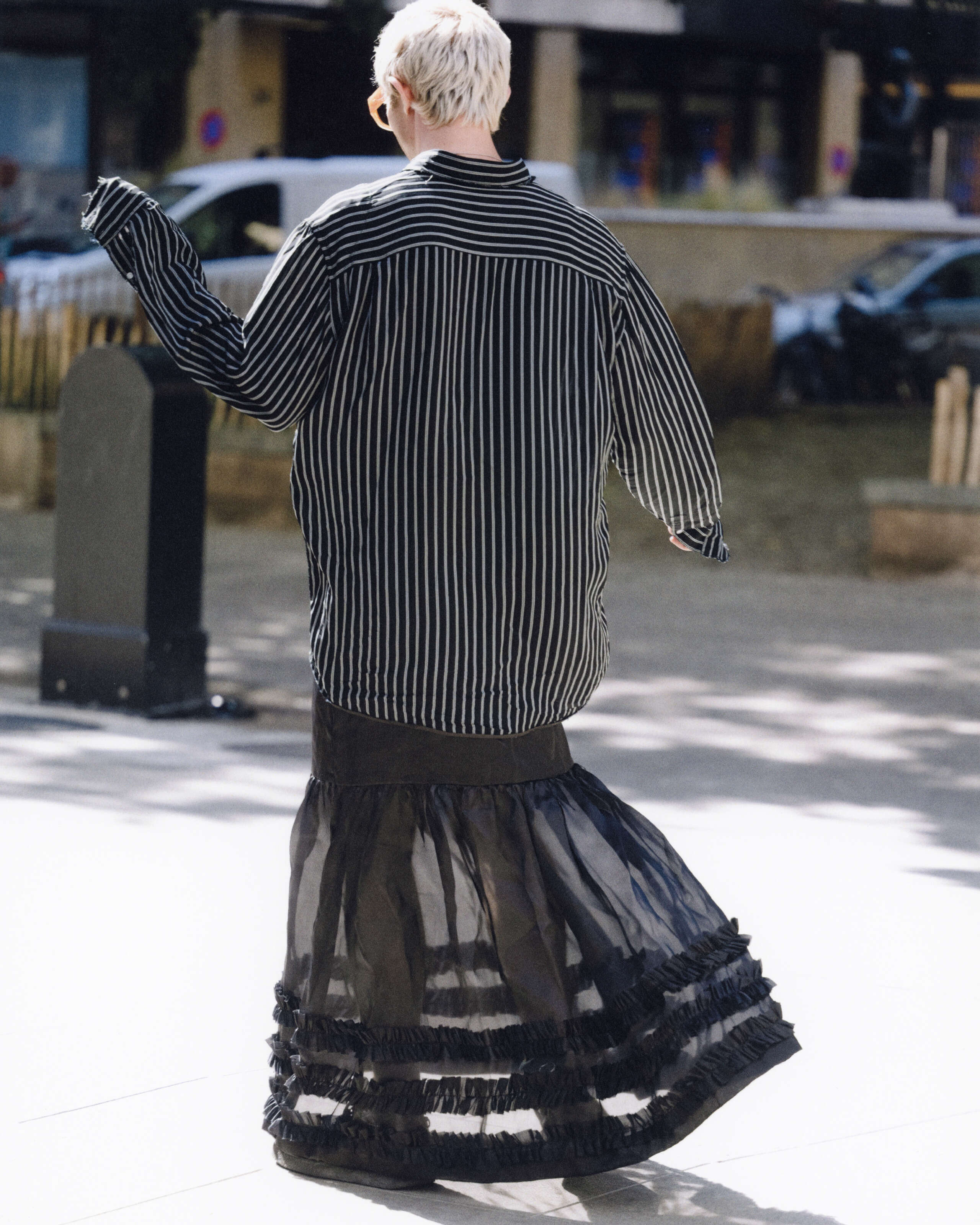 Young man wearing a black skirt and shirt
