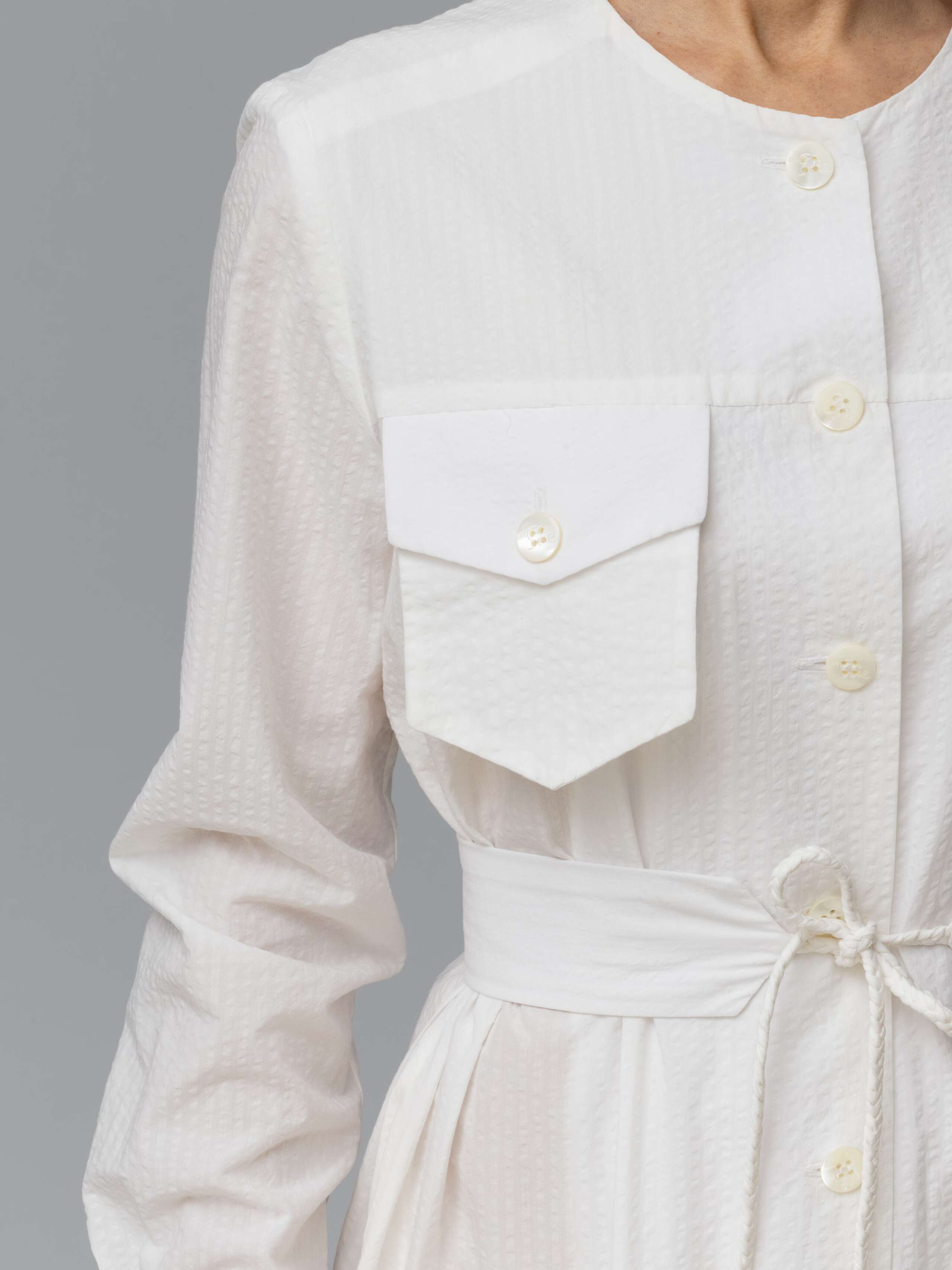 Detail of a long white seersucker summer dress