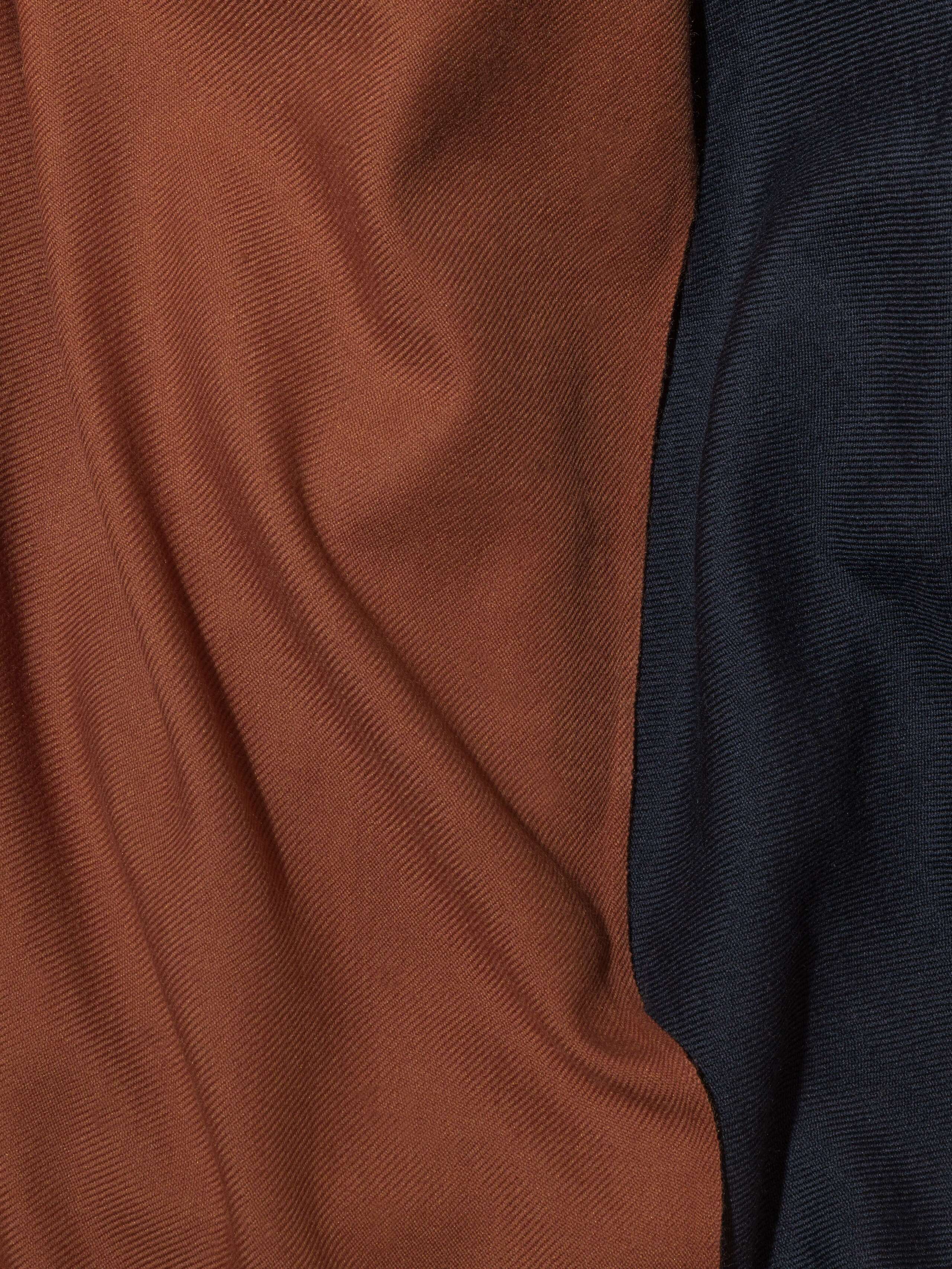 Picture of a detail of a beautiful wool scarf in a warm cognac shade