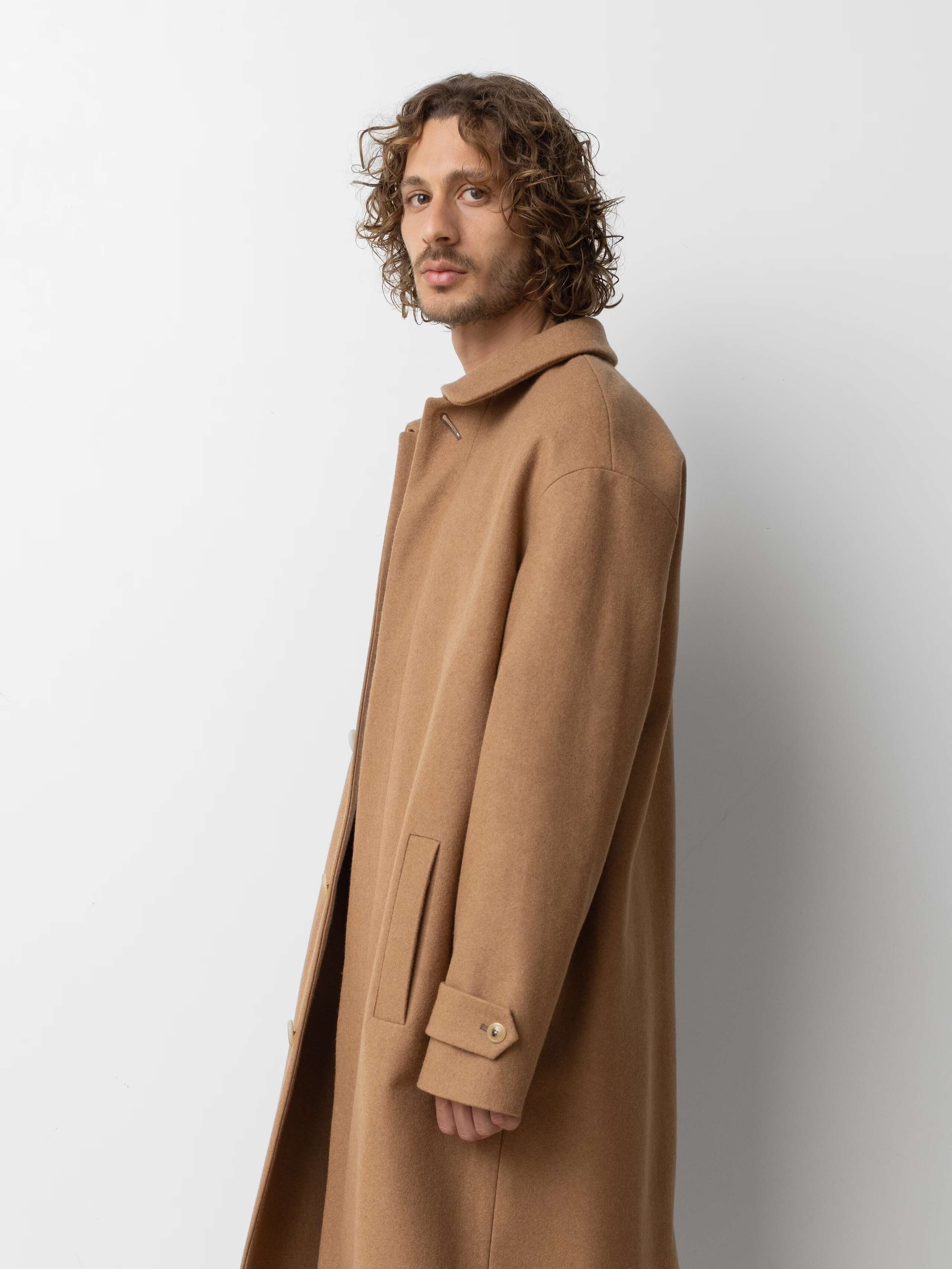 Picture of a male model wearing a classic beige winter wool coat