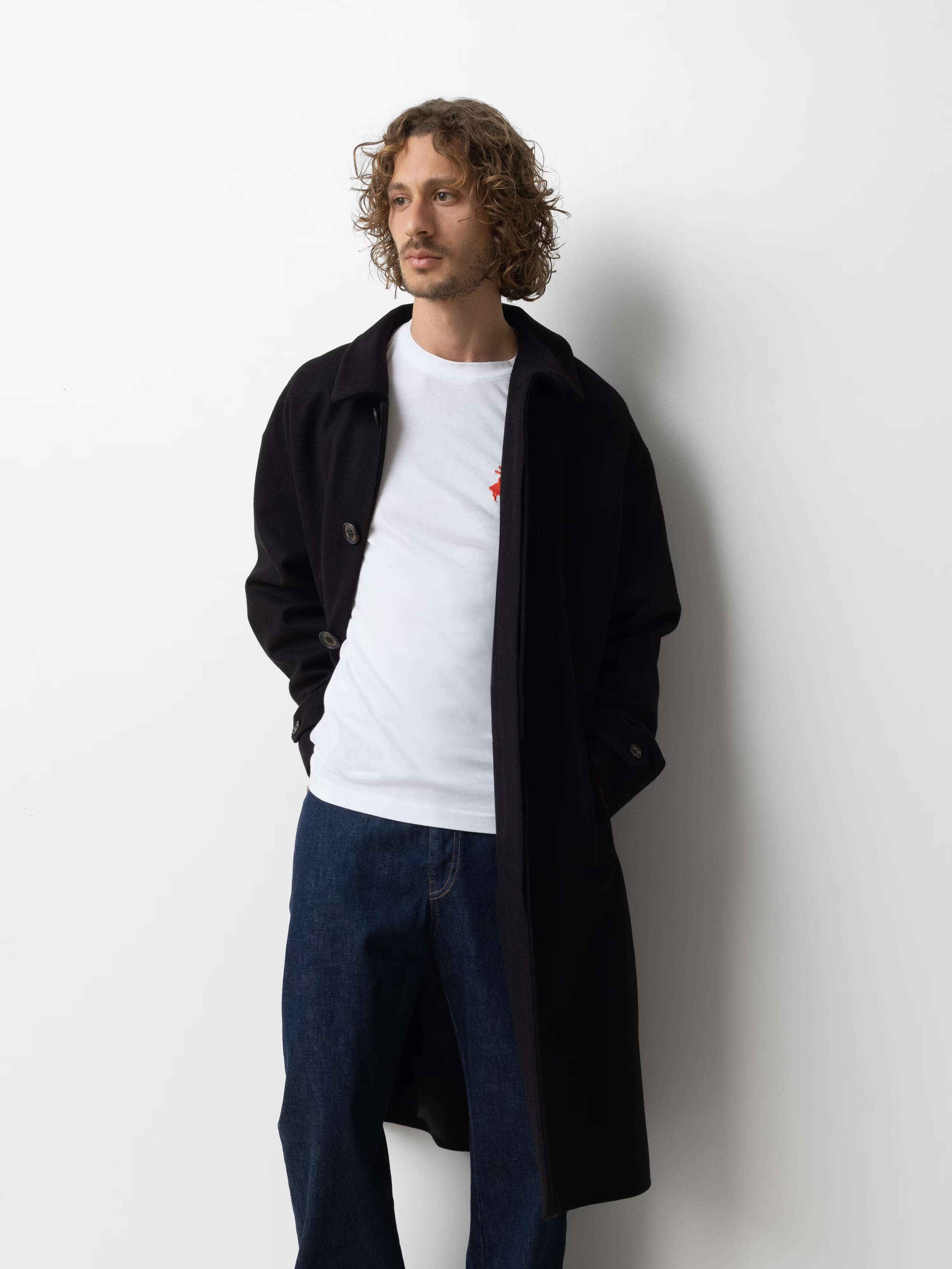 Picture of a male model wearing a classic black winter coat