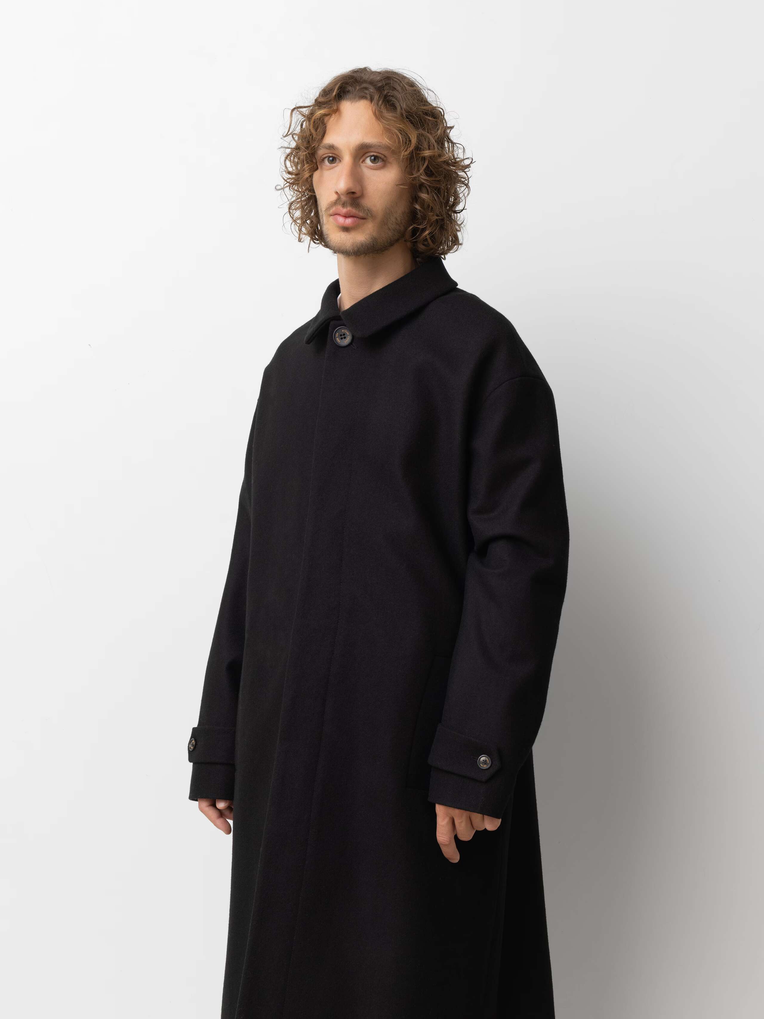 Picture of a male model wearing a classic black winter coat