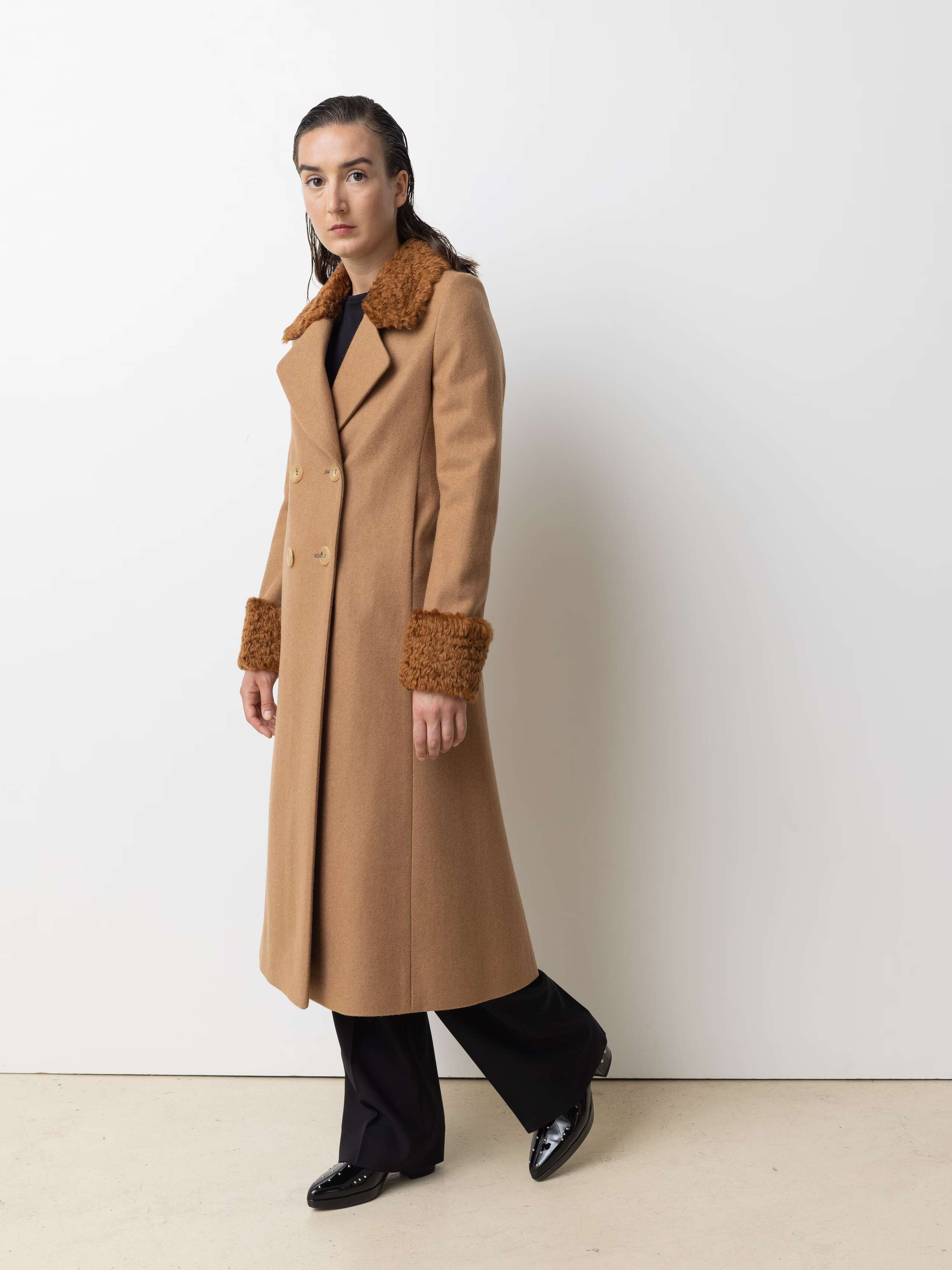 Picture of a female model wearing a beige winter coat