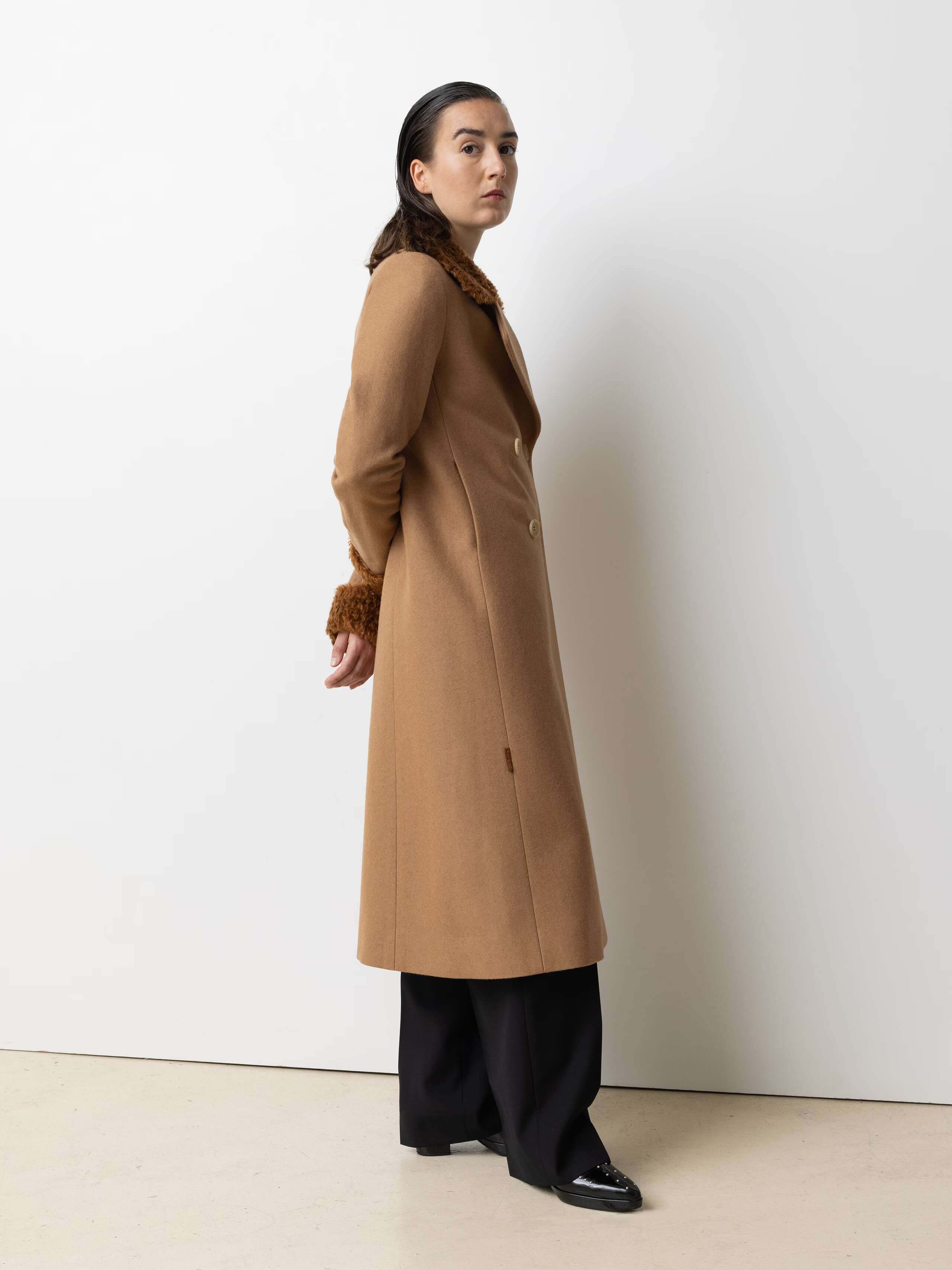 Picture of a female model wearing a beige winter coat