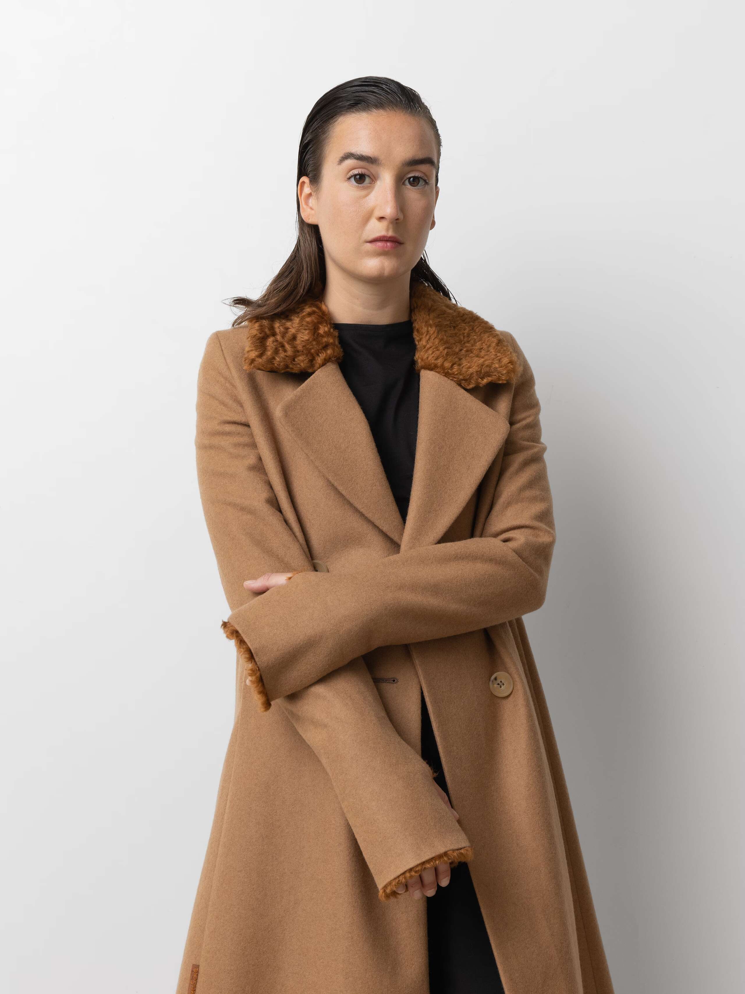 Picture of a female model wearing a beige winter coat