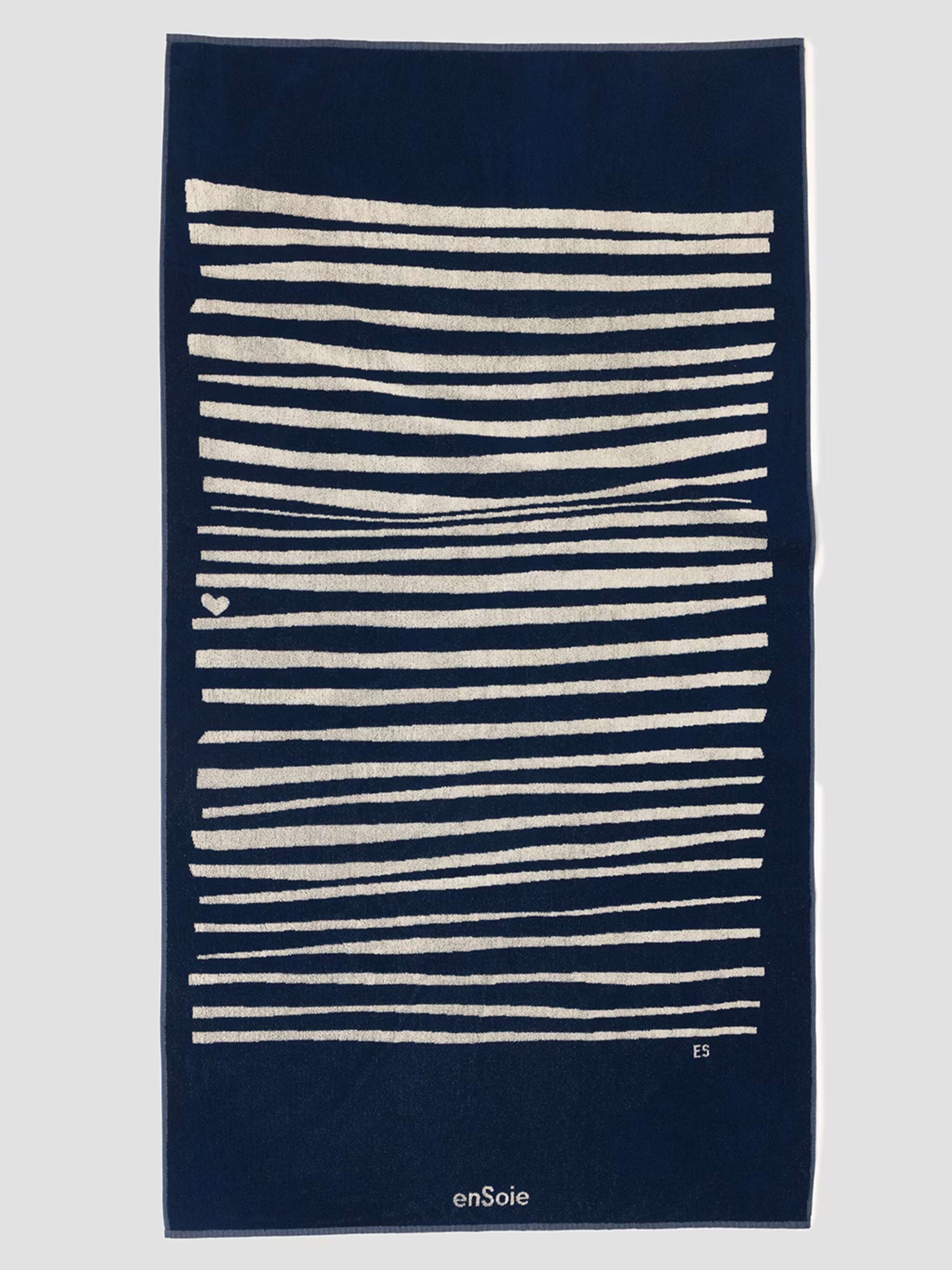 Picture of a frotté bath towel in dark blue featuring beige stripes