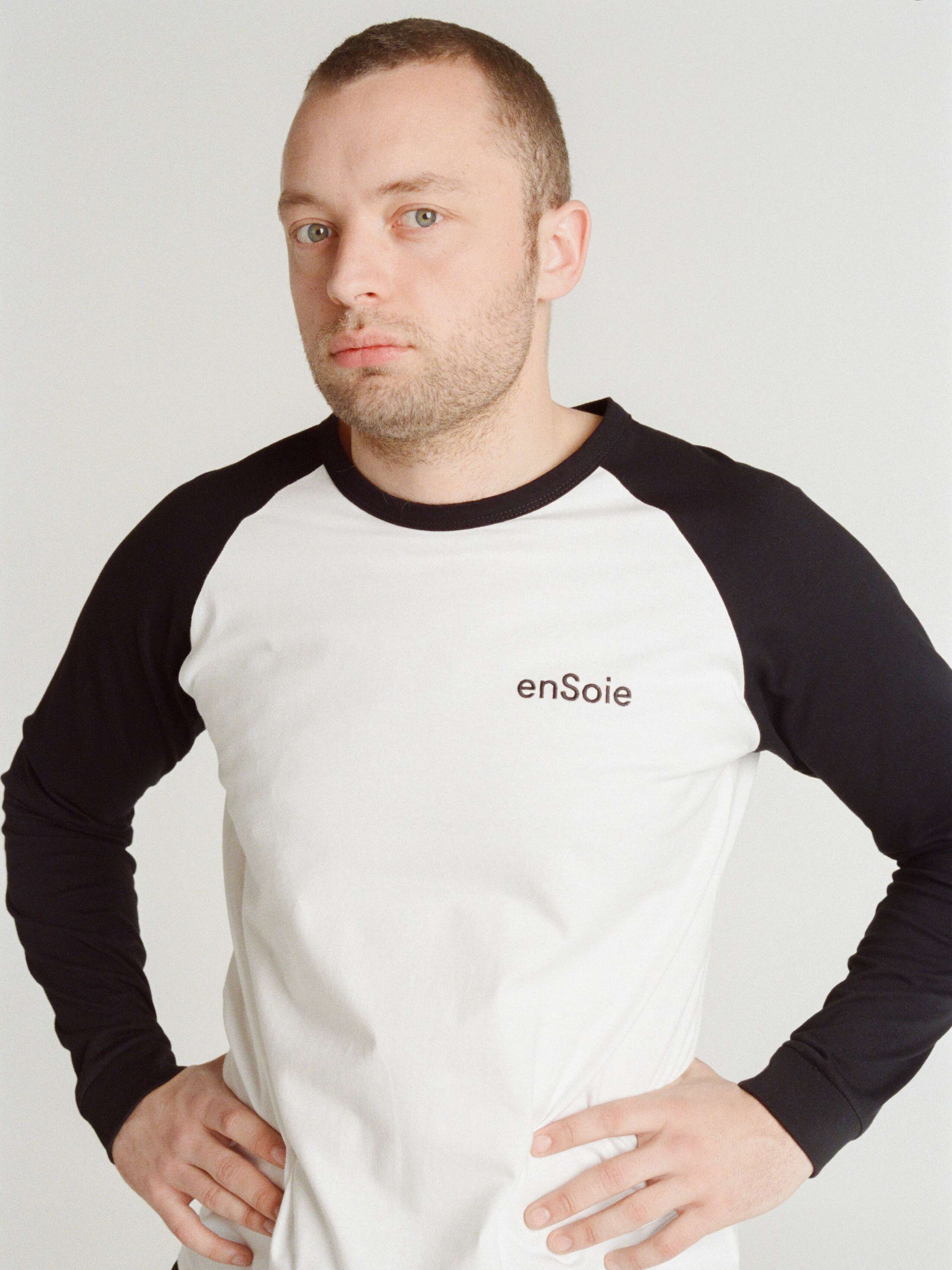 Francis wearing the raglan Joe long-sleeve shirt in black and white with enSoie print
