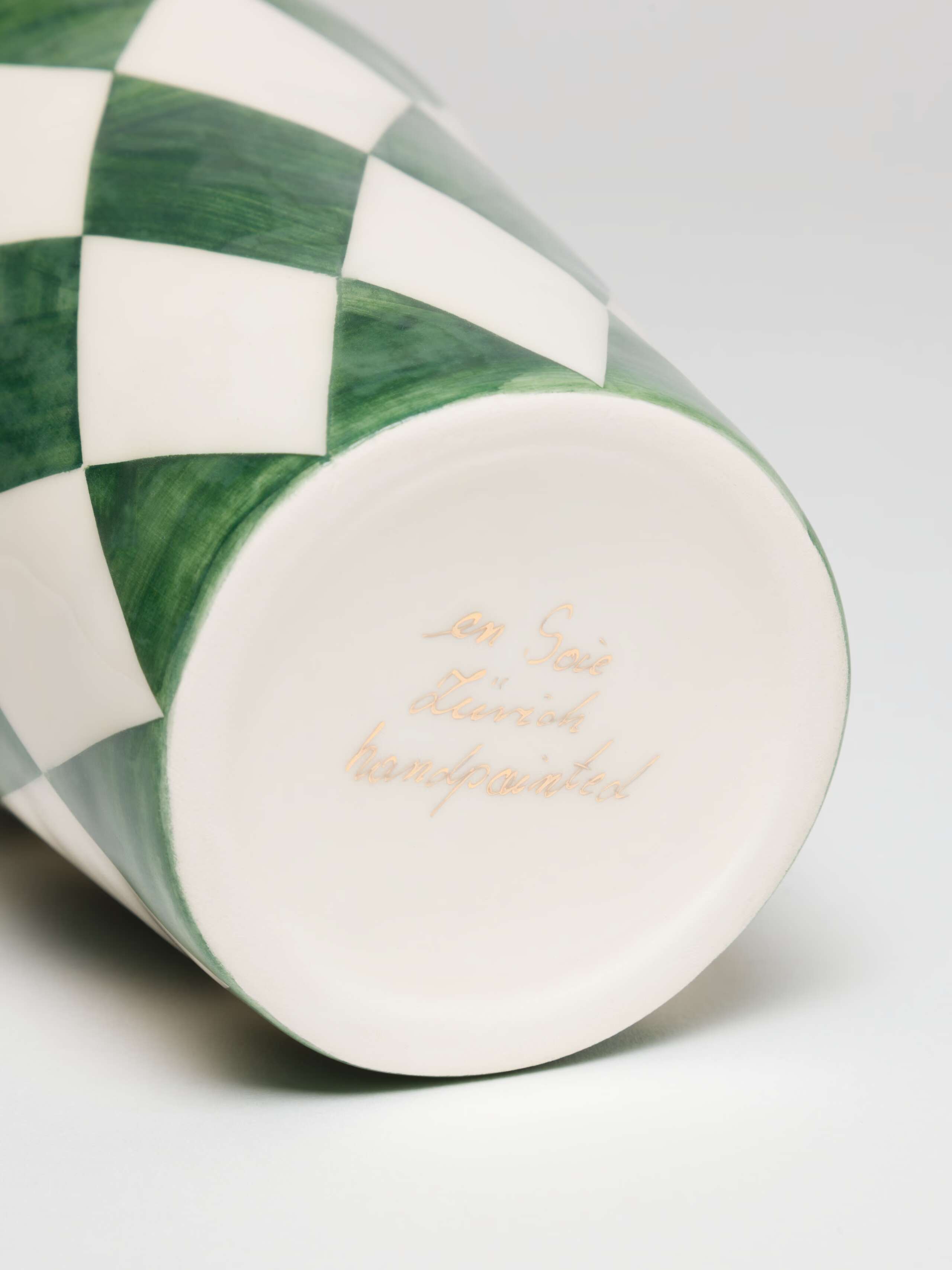 Handwritten Signature on bottom of cup