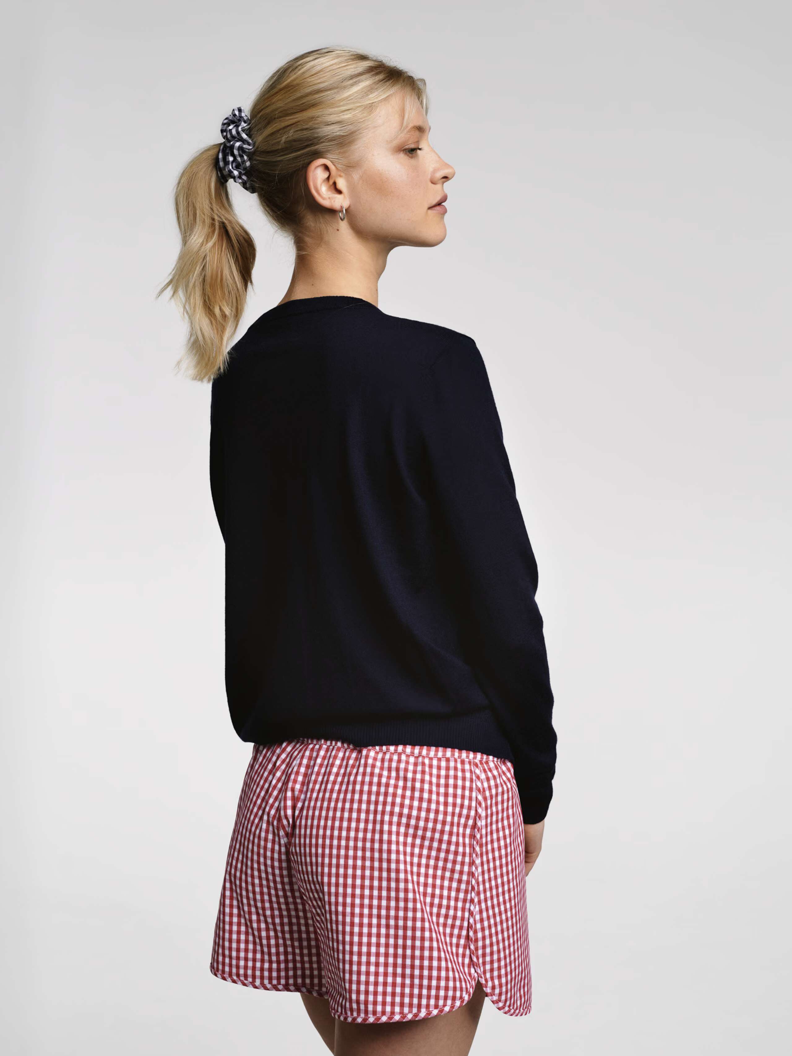 Model wearing the red vichy check dionne shorts