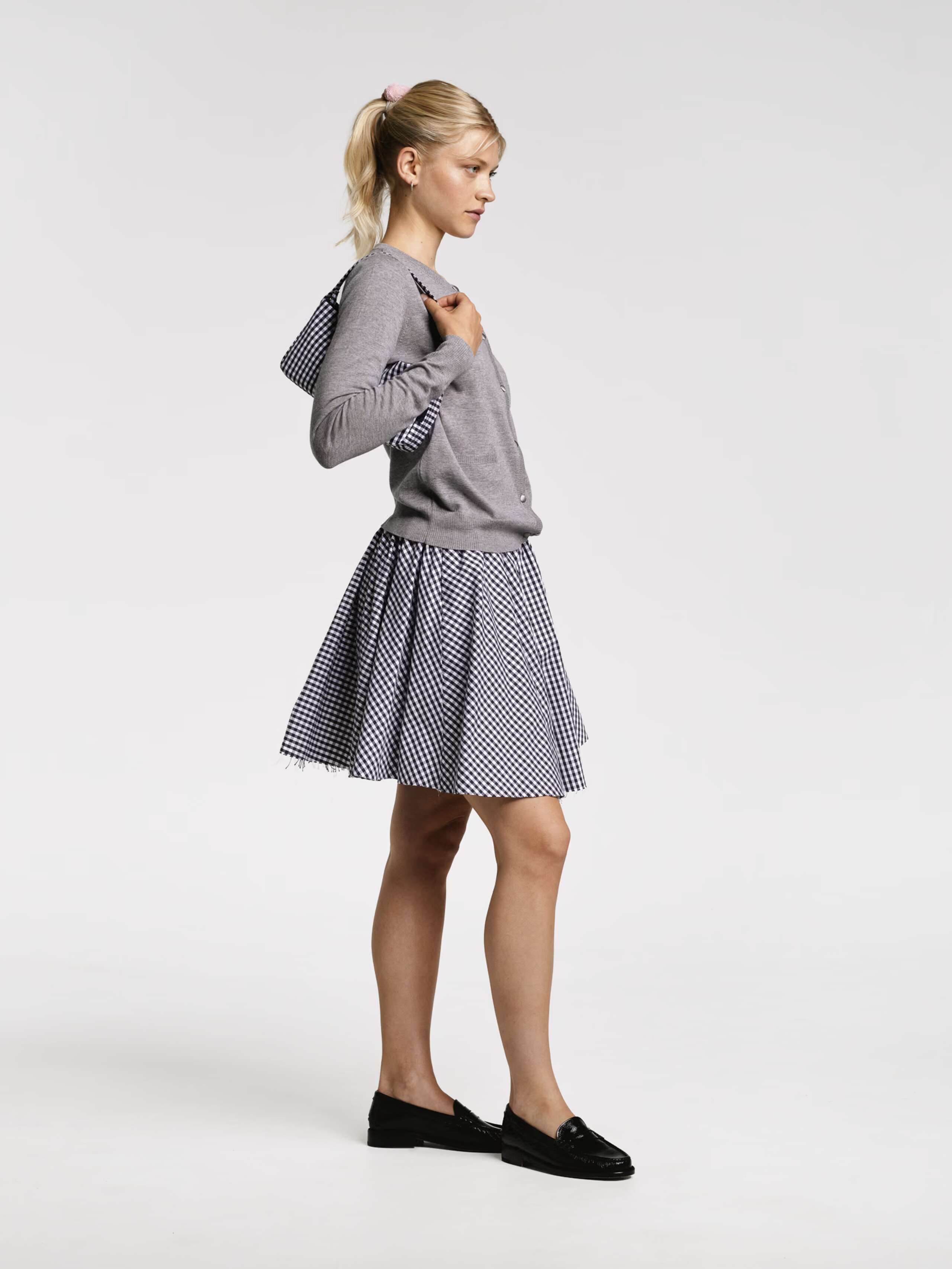 Models wearing the Berta short skirt in vichy check red and Navy