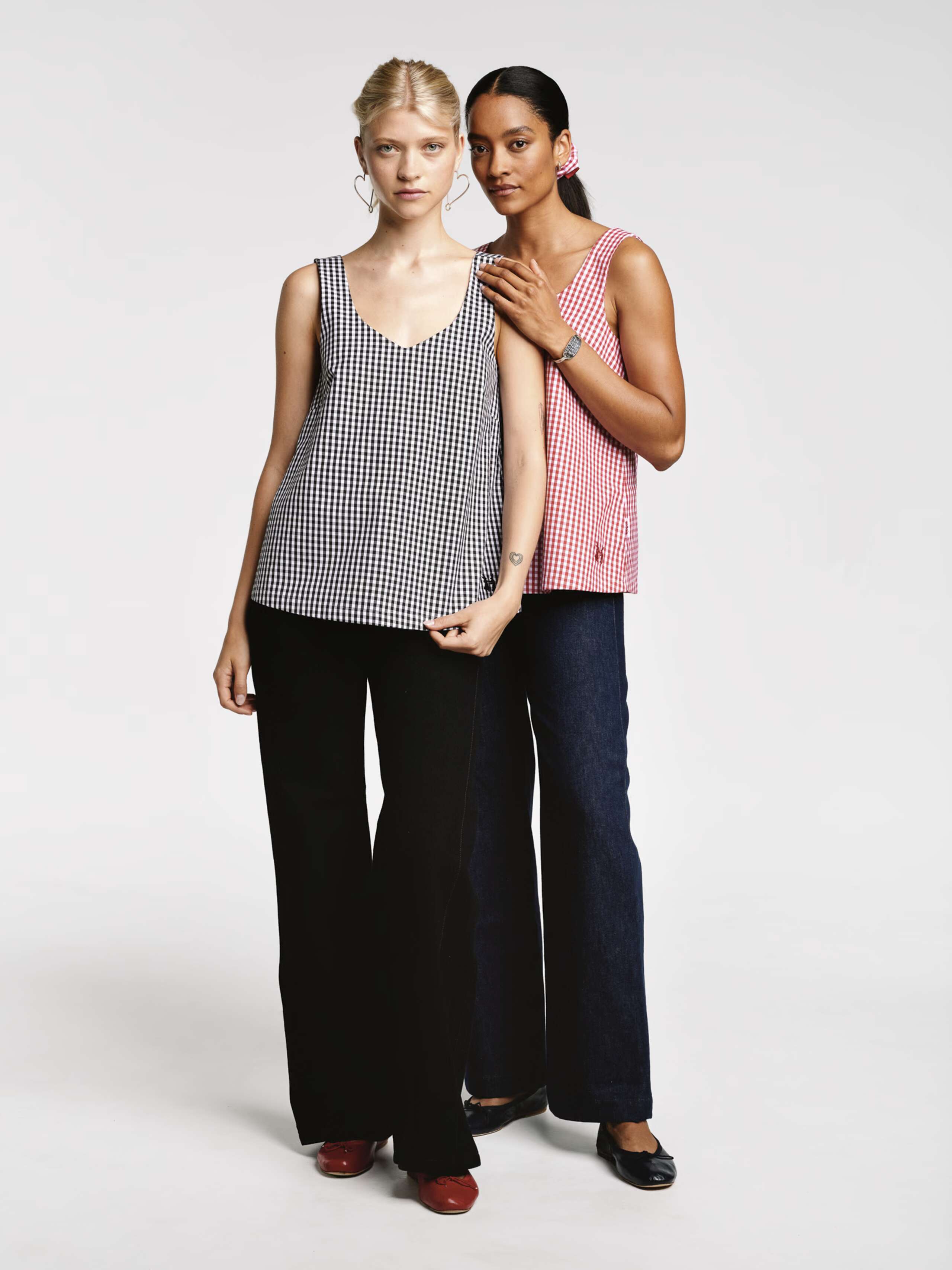 Models wearing the Tia top sleeveless in red vichy check and black vichy check