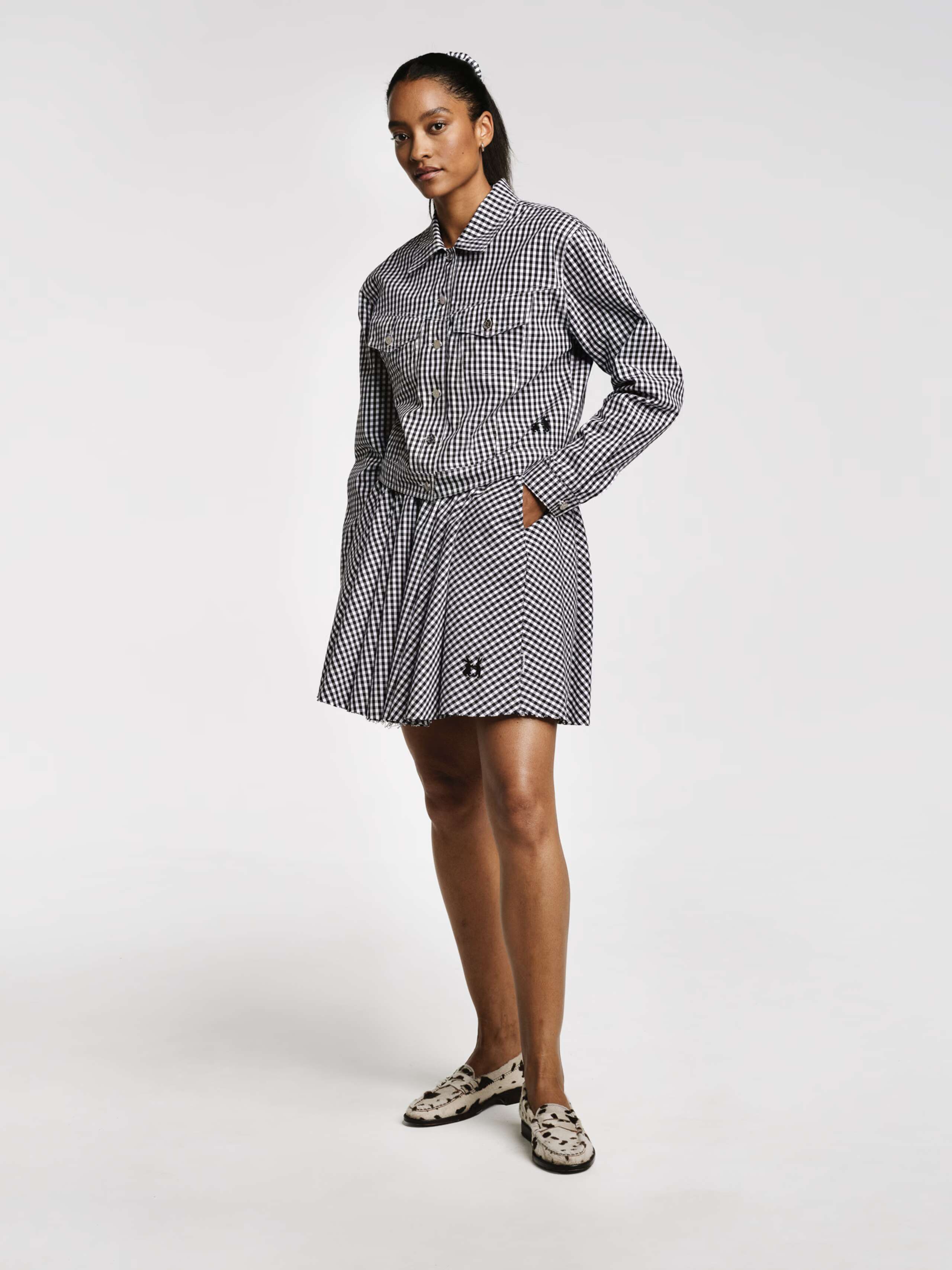 Model wearing the Berta short skirt in vichy check black