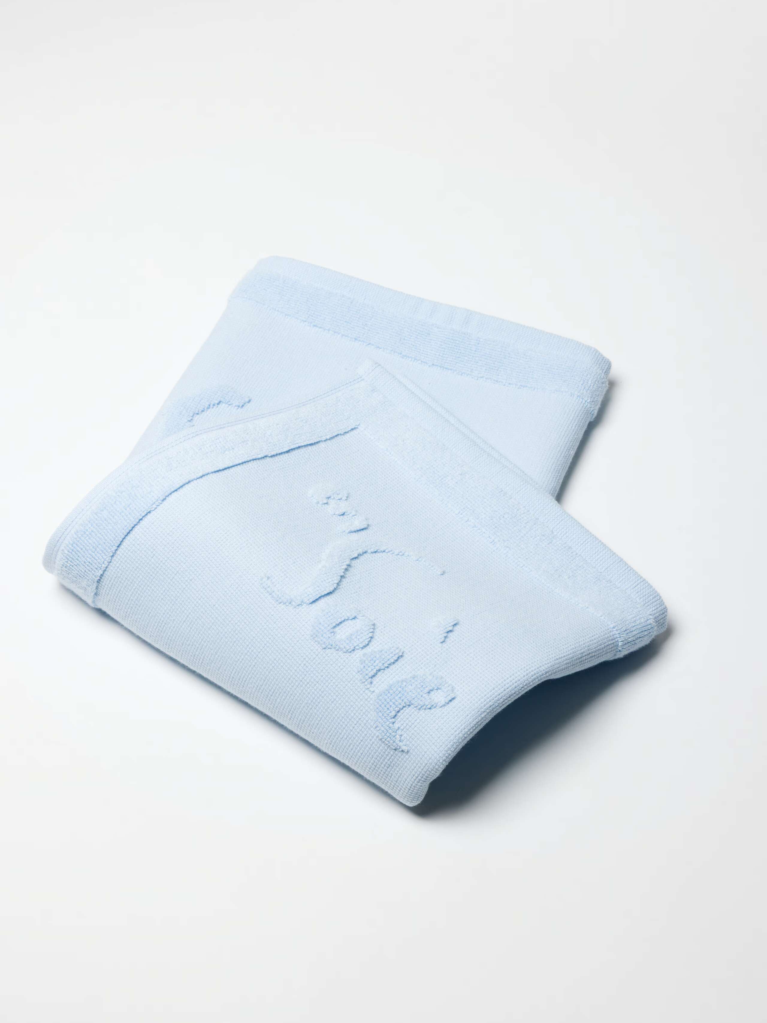 Soft Cerulean Blue terry bath mat with rabbits and logo