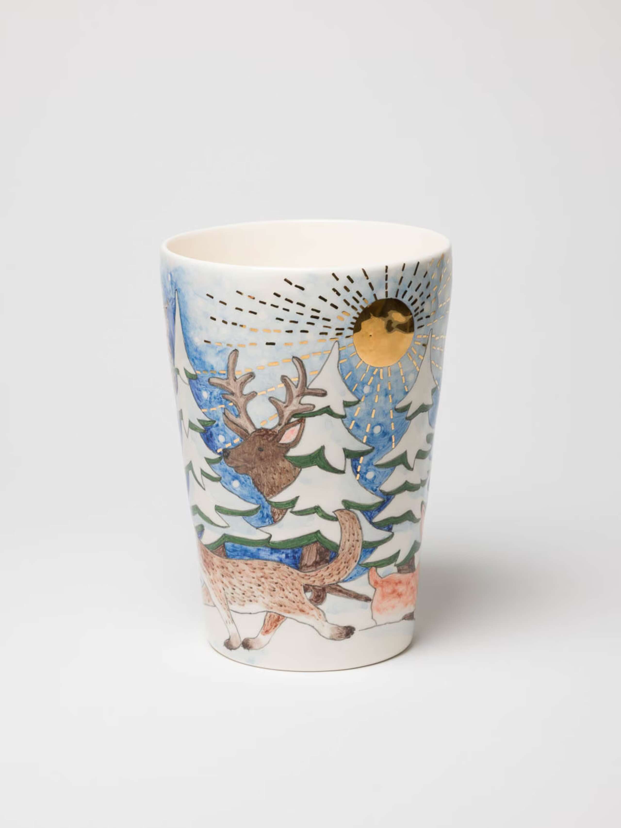 A picture of a beautifully hand-painted vase featuring a magnificent winter landscape.