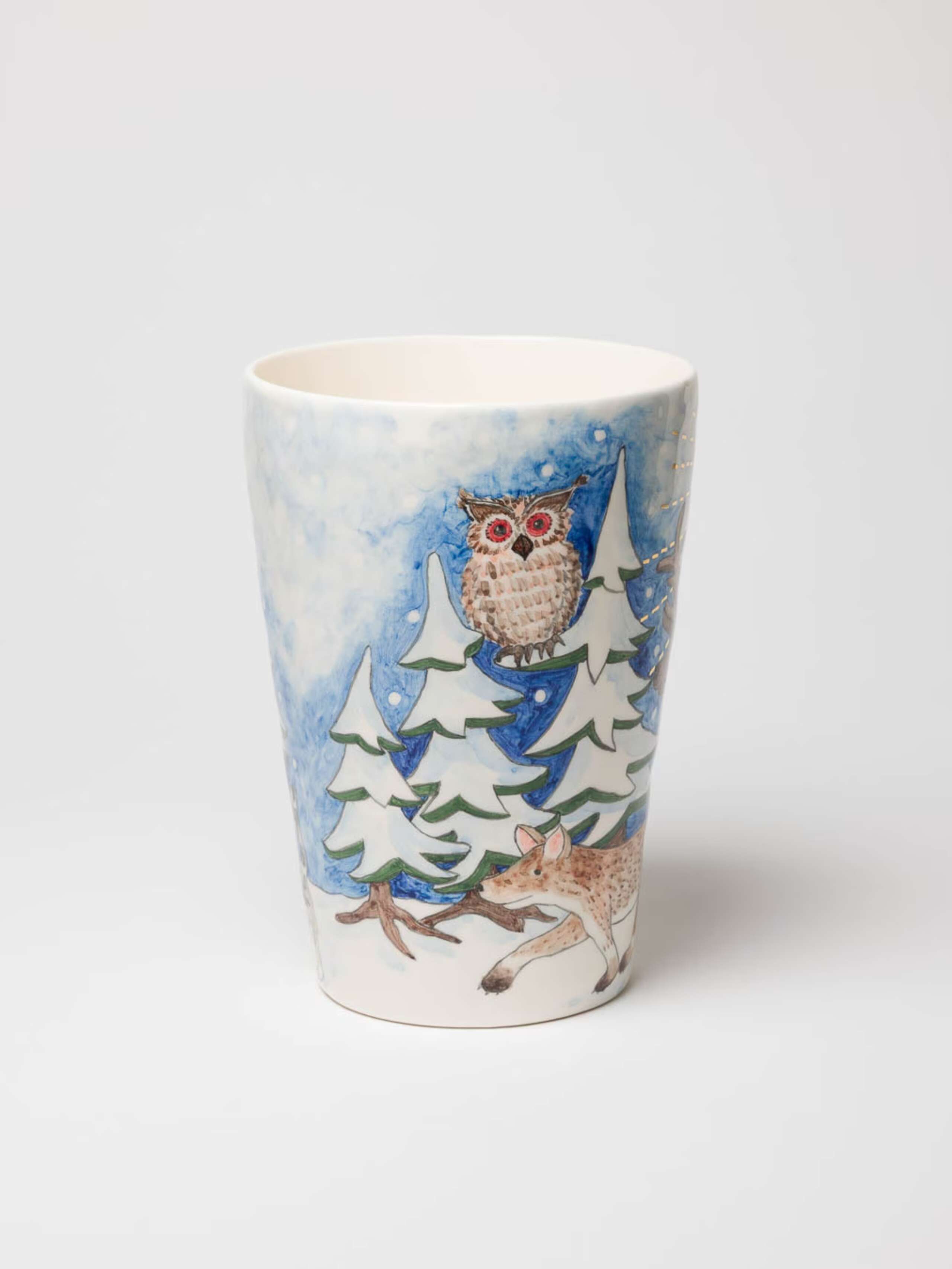 A picture of a beautifully hand-painted vase featuring a magnificent winter landscape.
