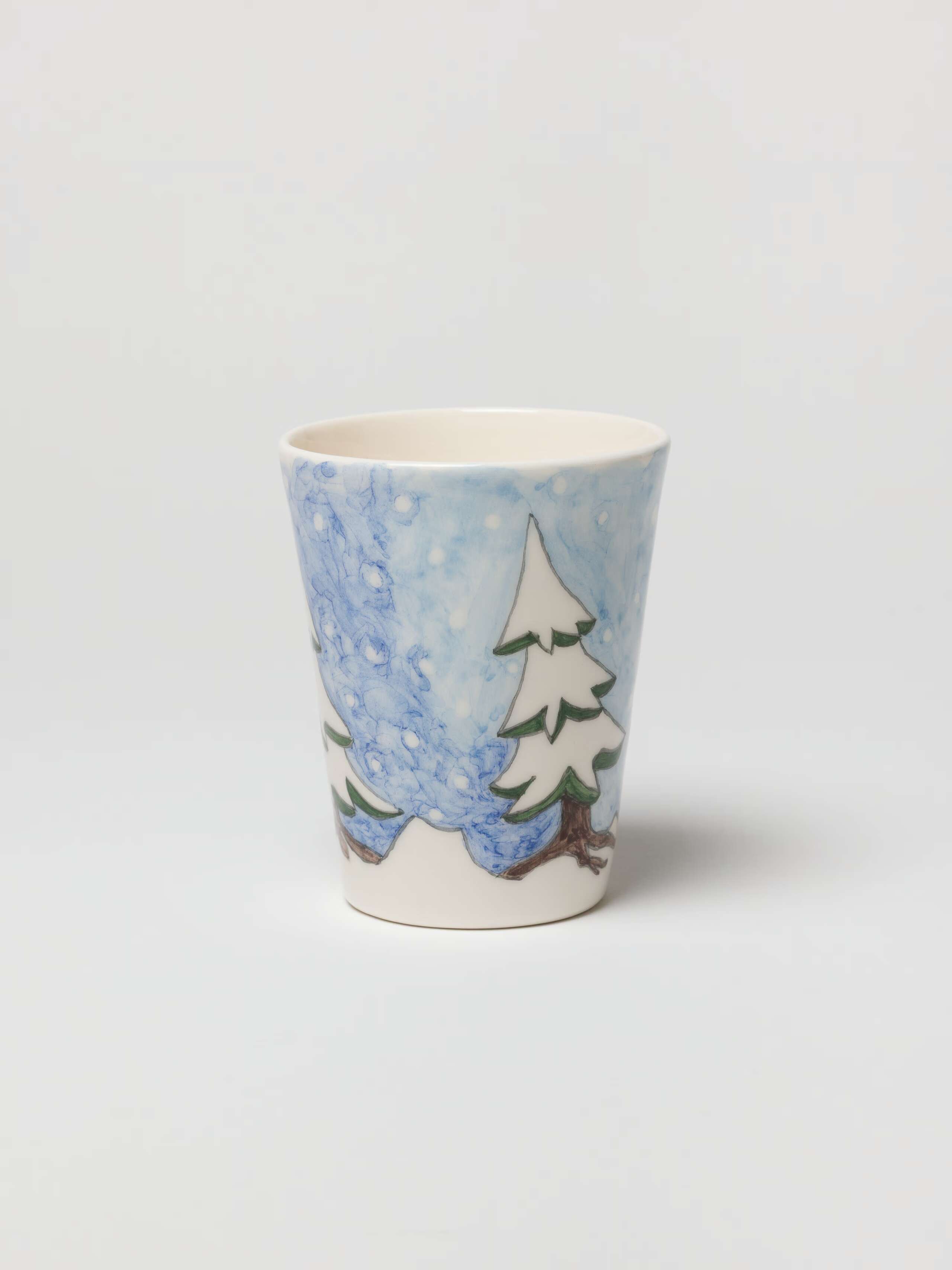 Picture of a hand-painted cup with a winterland motif.