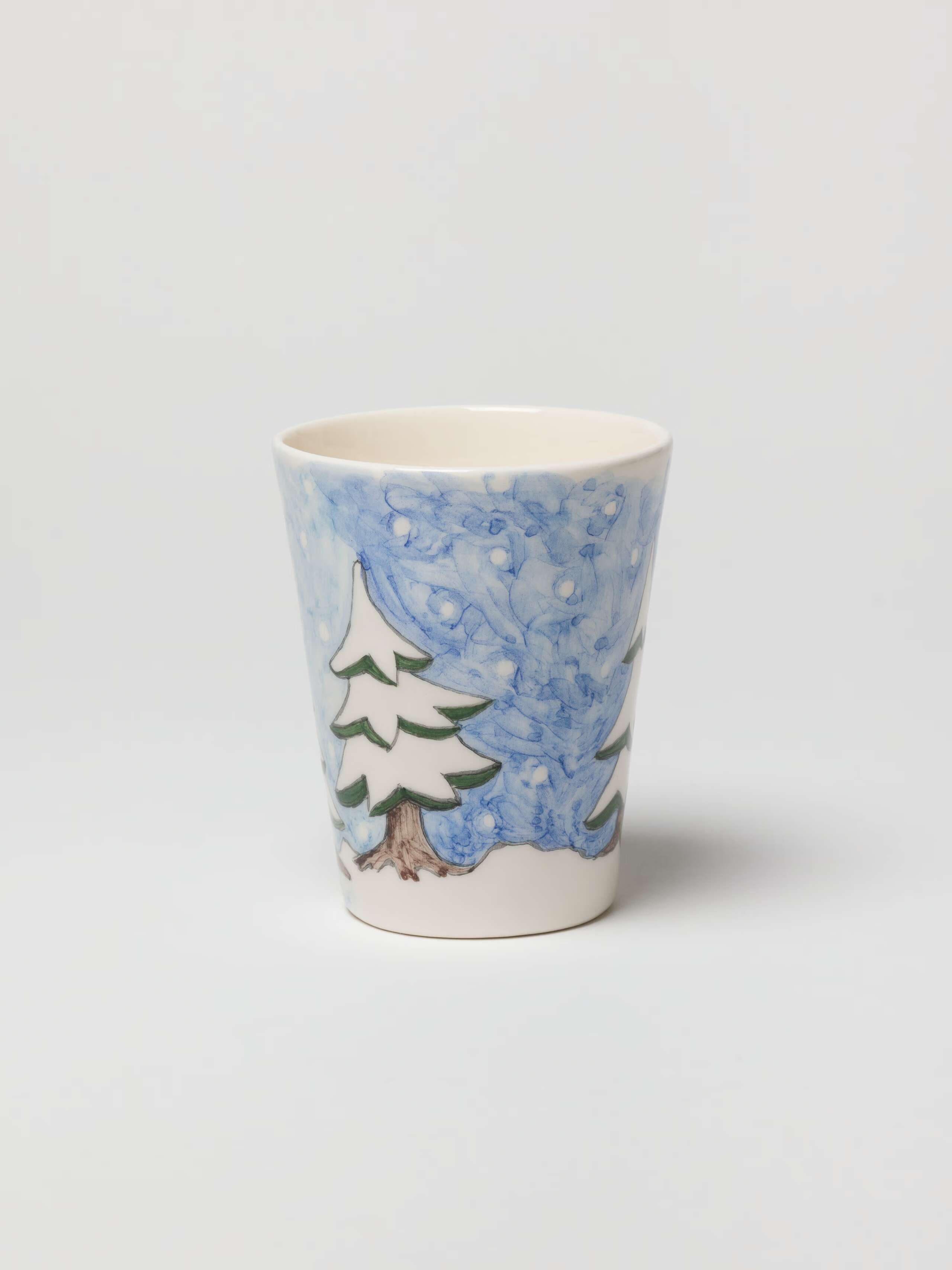 Picture of a hand-painted cup with a winterland motif.