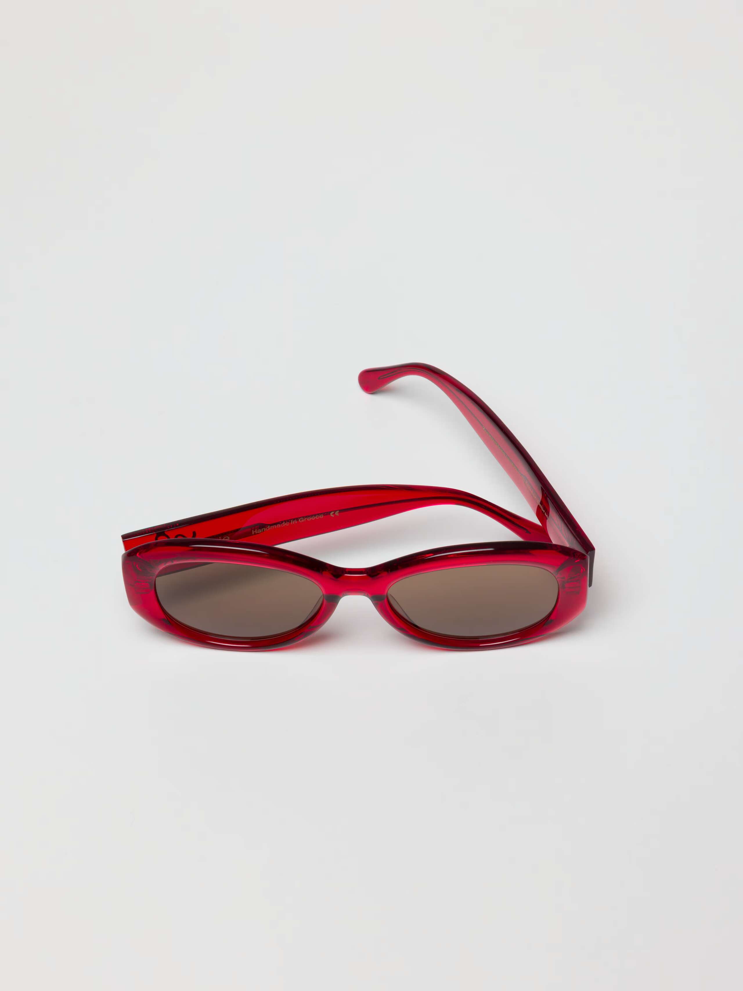 Overhead Shot of slightly folded Capri Sunglasses in Red