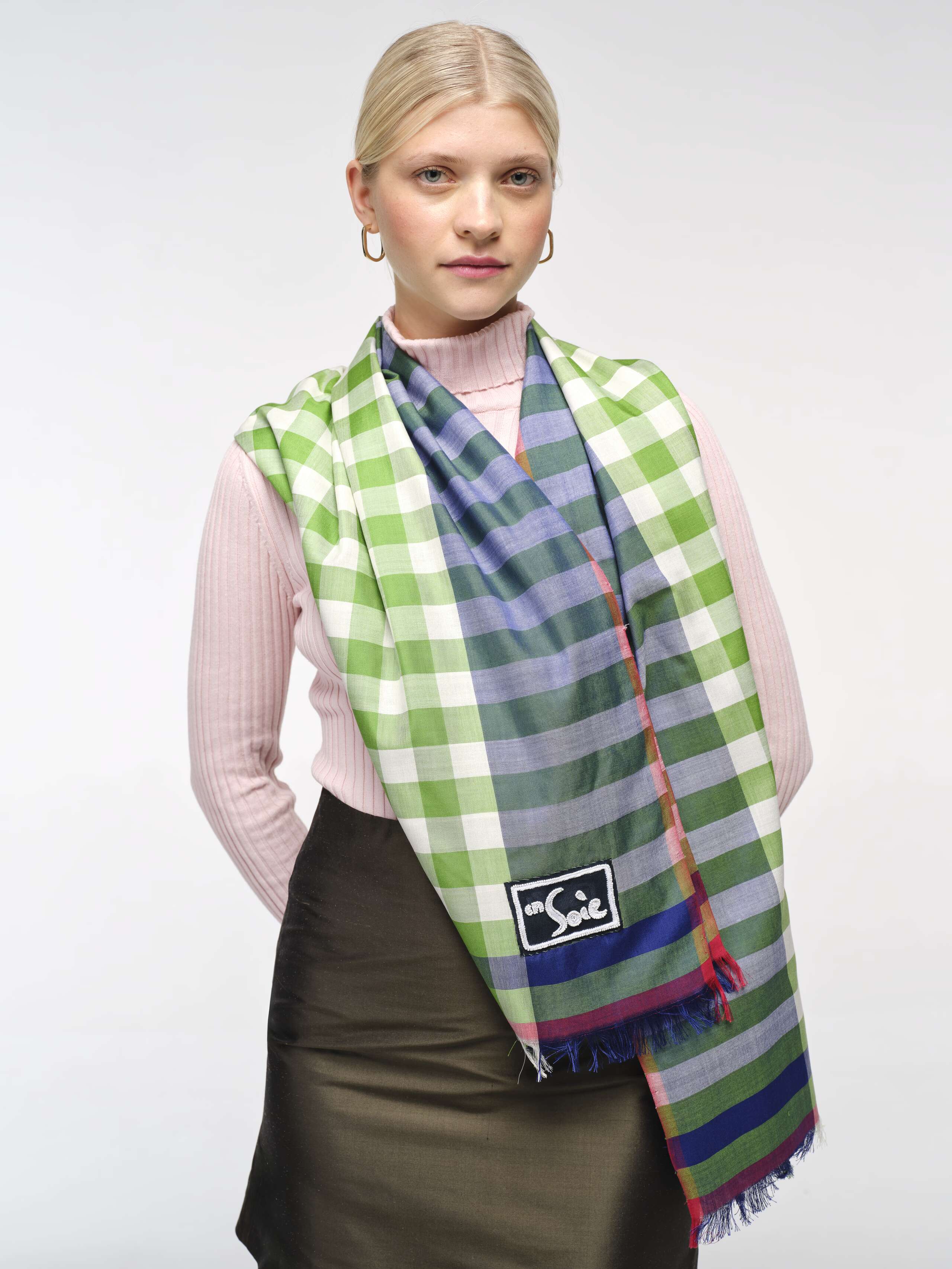 closeup front shot of model wearing blue-green satu woven silk scarf draped over shoulders 