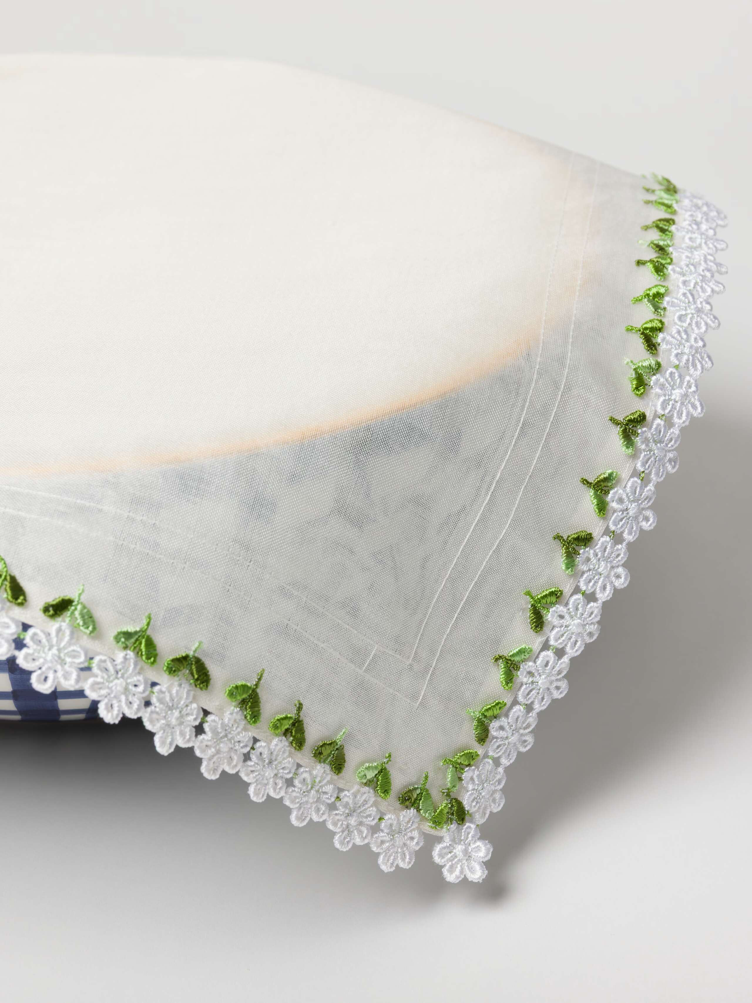 Bibi bowl cover made out of silk. edges hand embroidered with white flowers