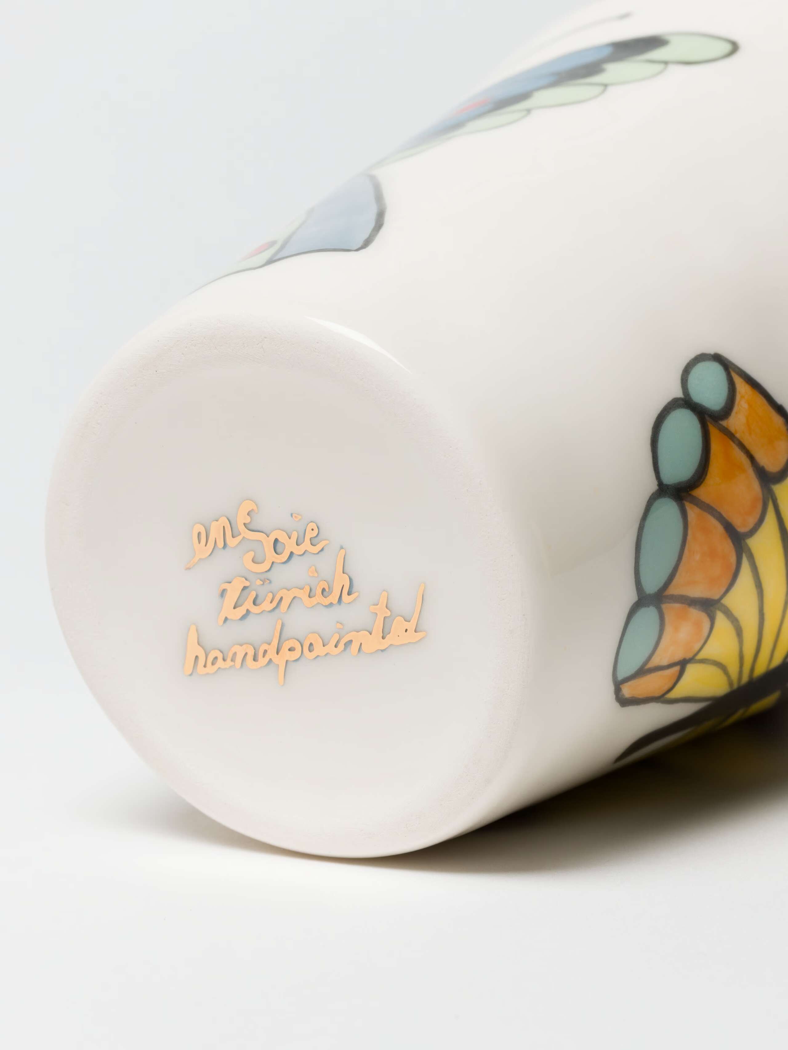 detail shot of bottom handpainted ensoie logo on XS vase with two butterflies 