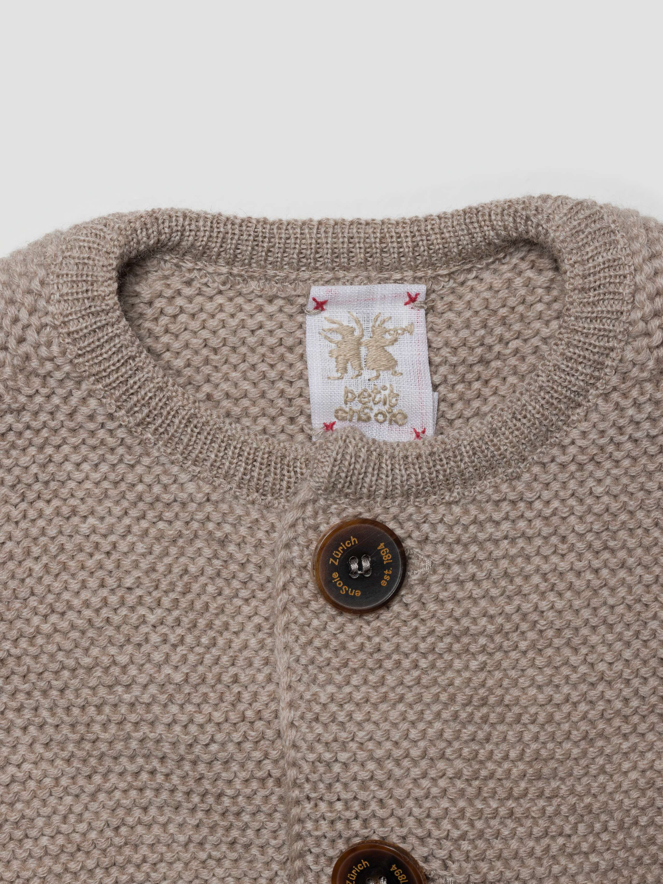 detail product shot of NEW BB chunky cardigan label in beige 