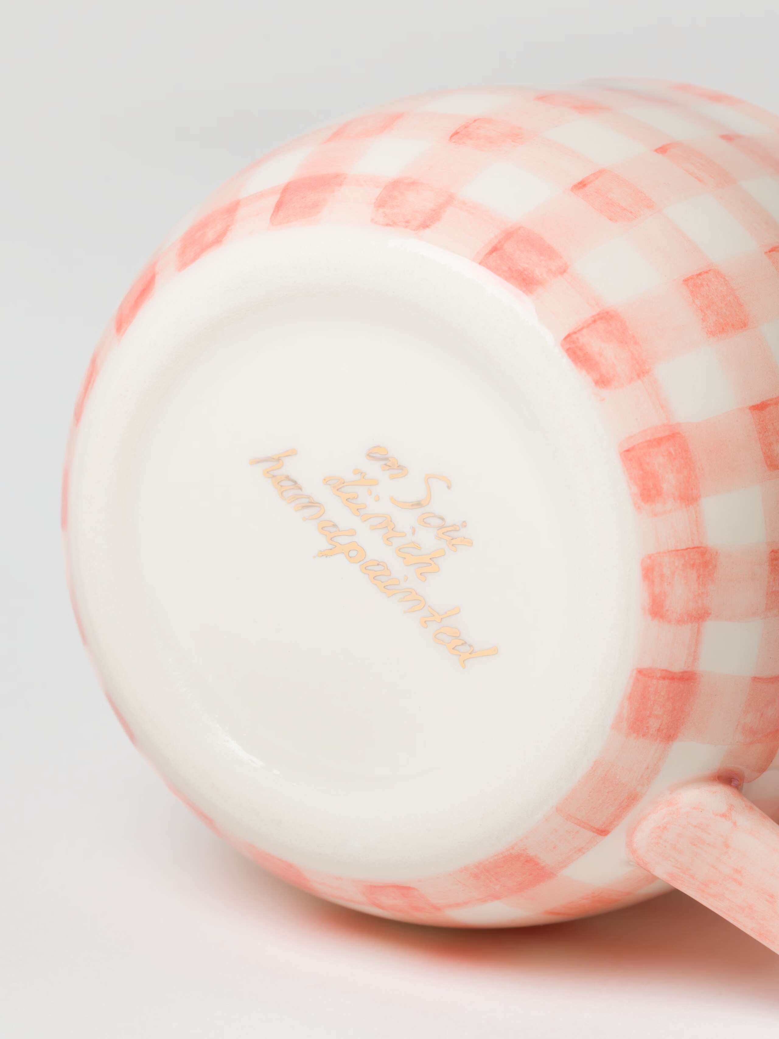 Bottom shot of cup in Candy Pink showing handprinted logo 