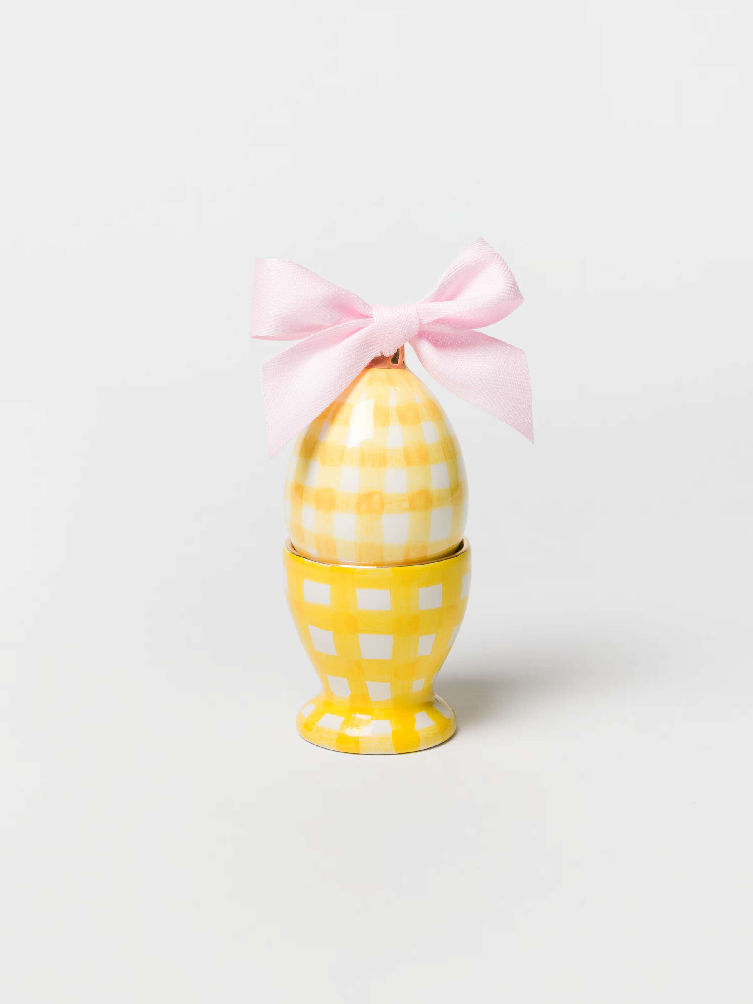 product shot of greta egg cup in sunny yellow with yellow Vichy egg ornament inside