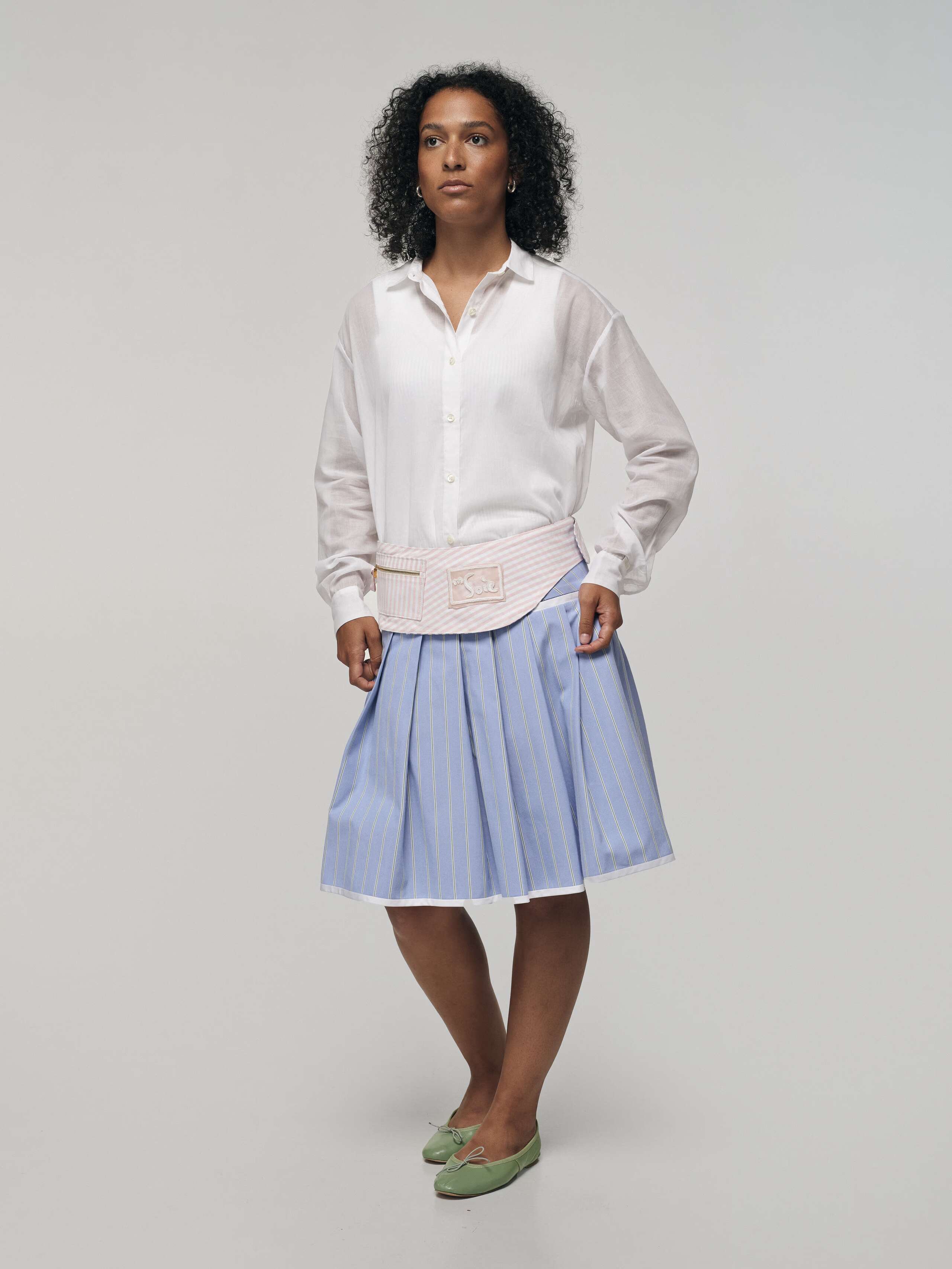 Product Shot of Belt Bag Blue Side on Model wearing Pine Skirt