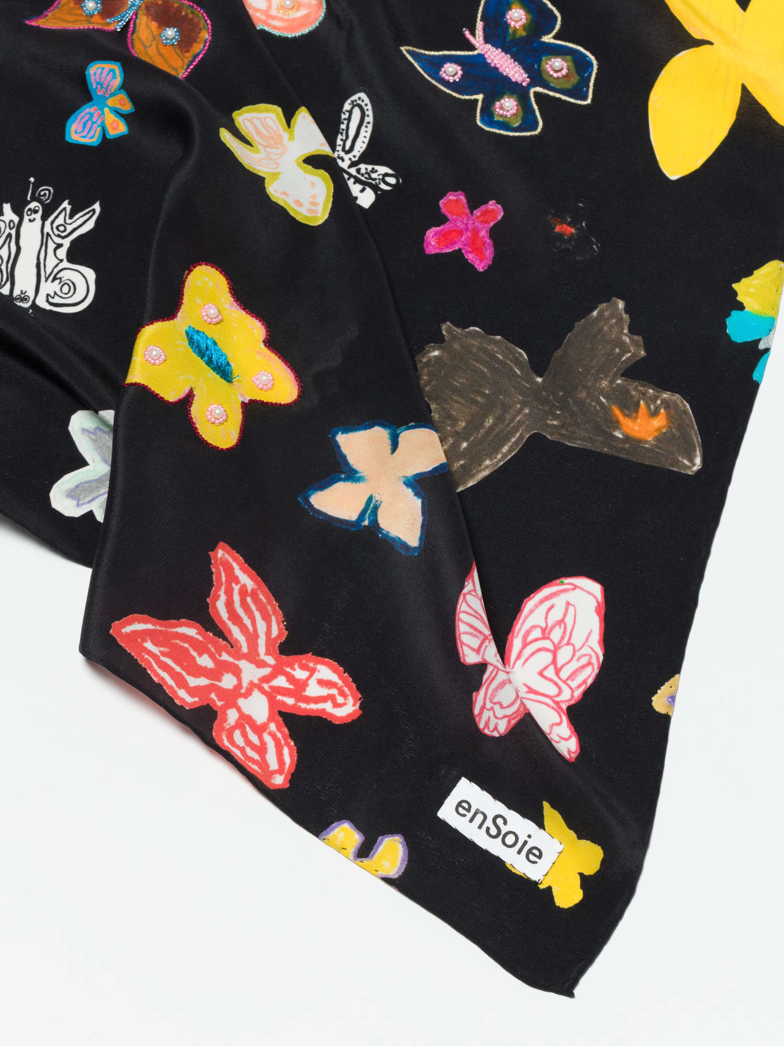 Detail shot of enSoie label on Carre Foulard in butterfly Print