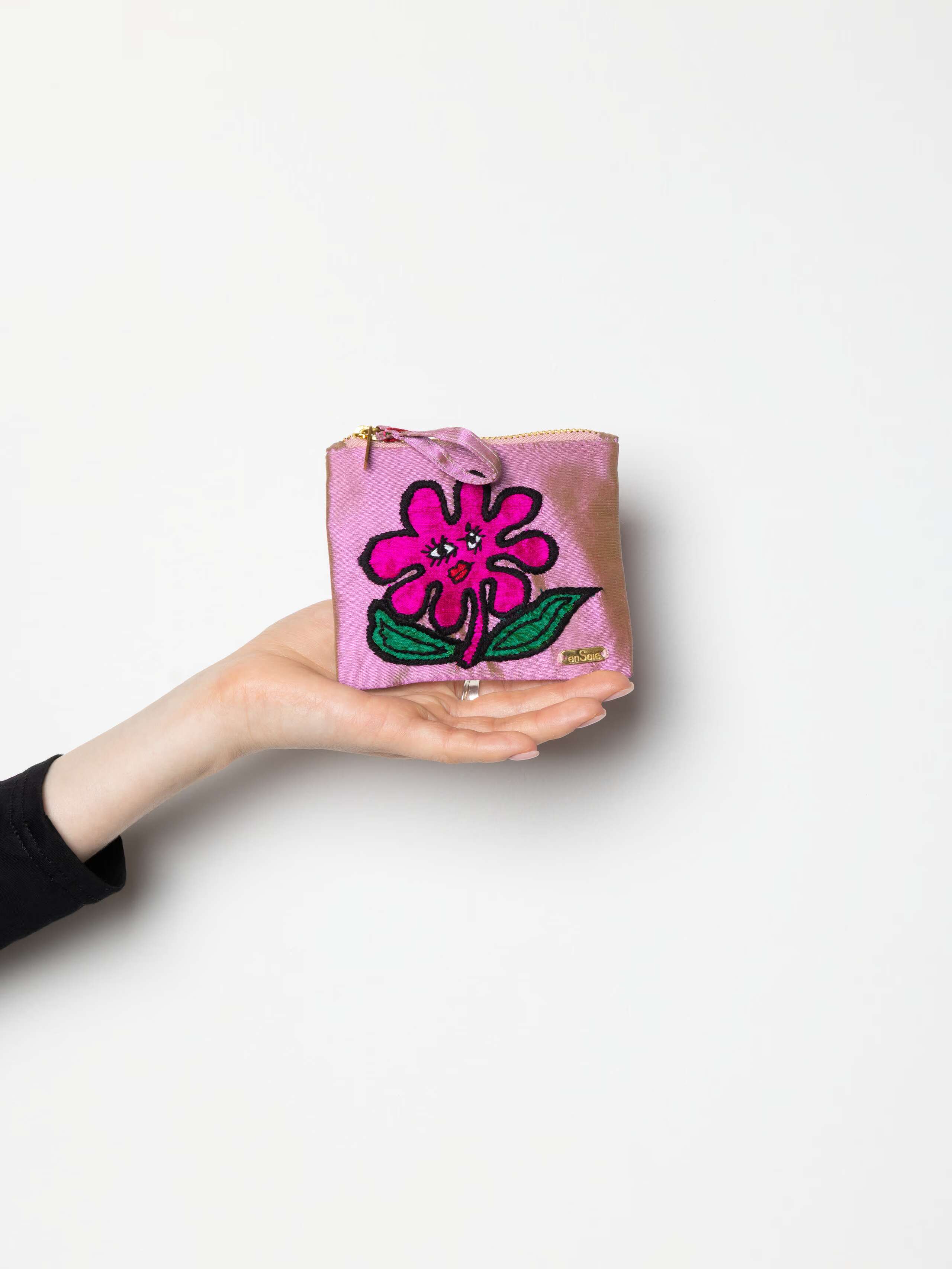 Product Shot for Spring Forest Pouch with flower in rose iridescent in hand 