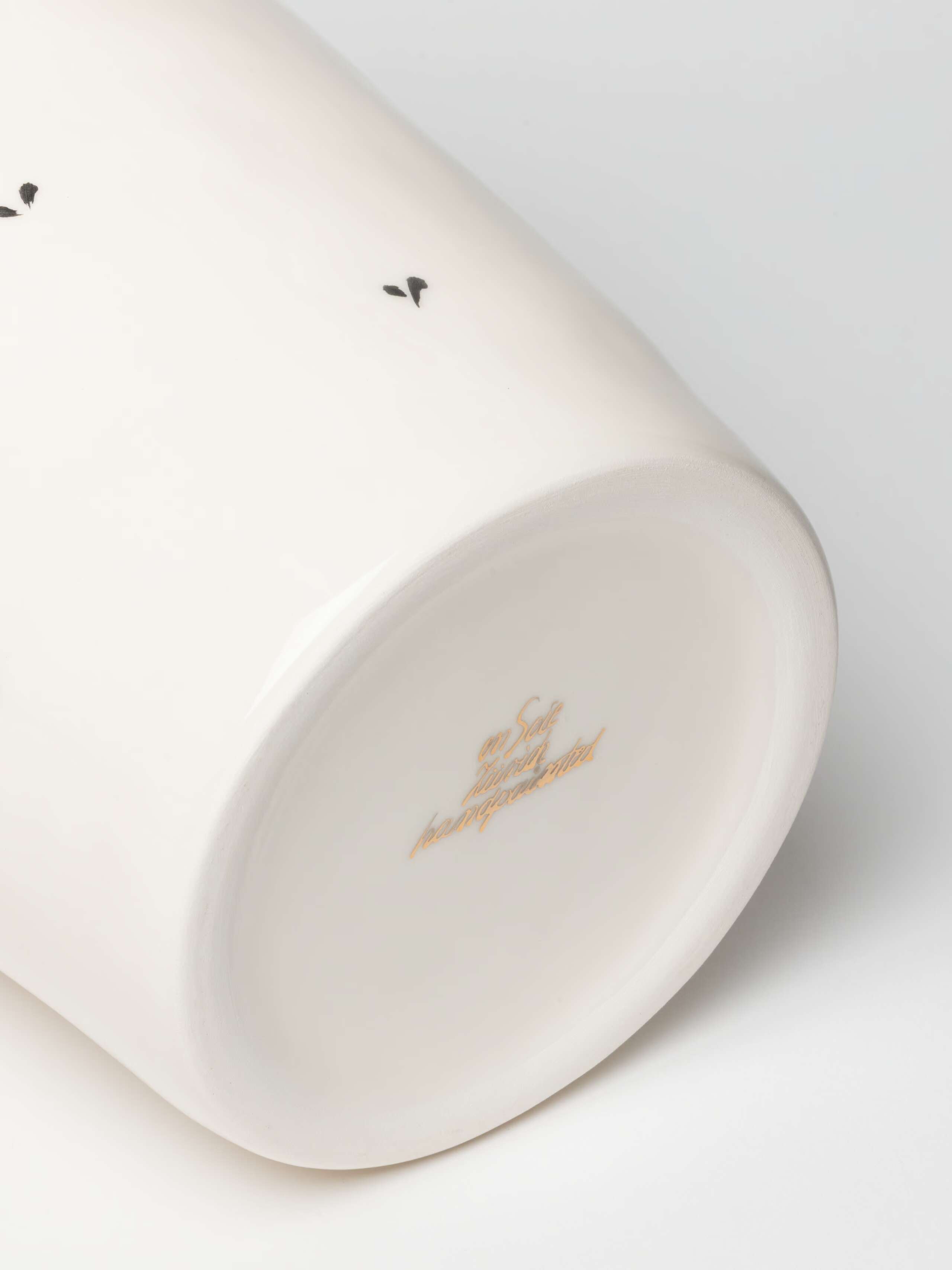 Detail Shot of gold logo on M vase  in Ermine