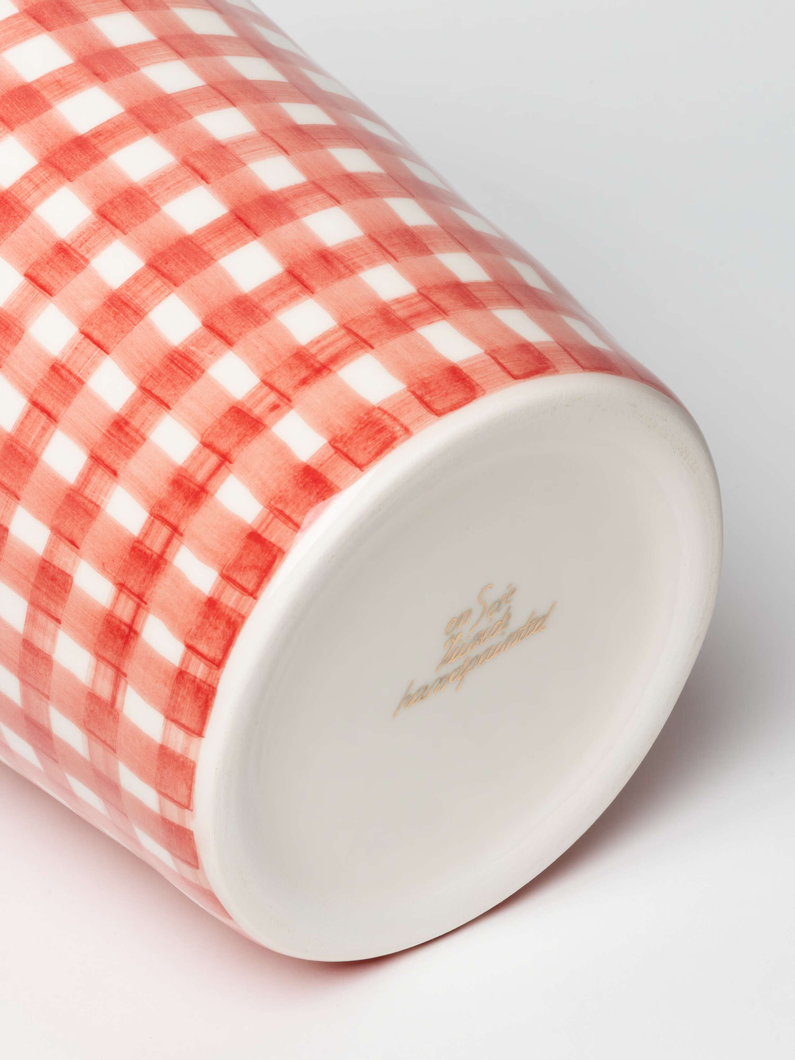 Detail Shot of gold logo on M vase  in enSoie Red