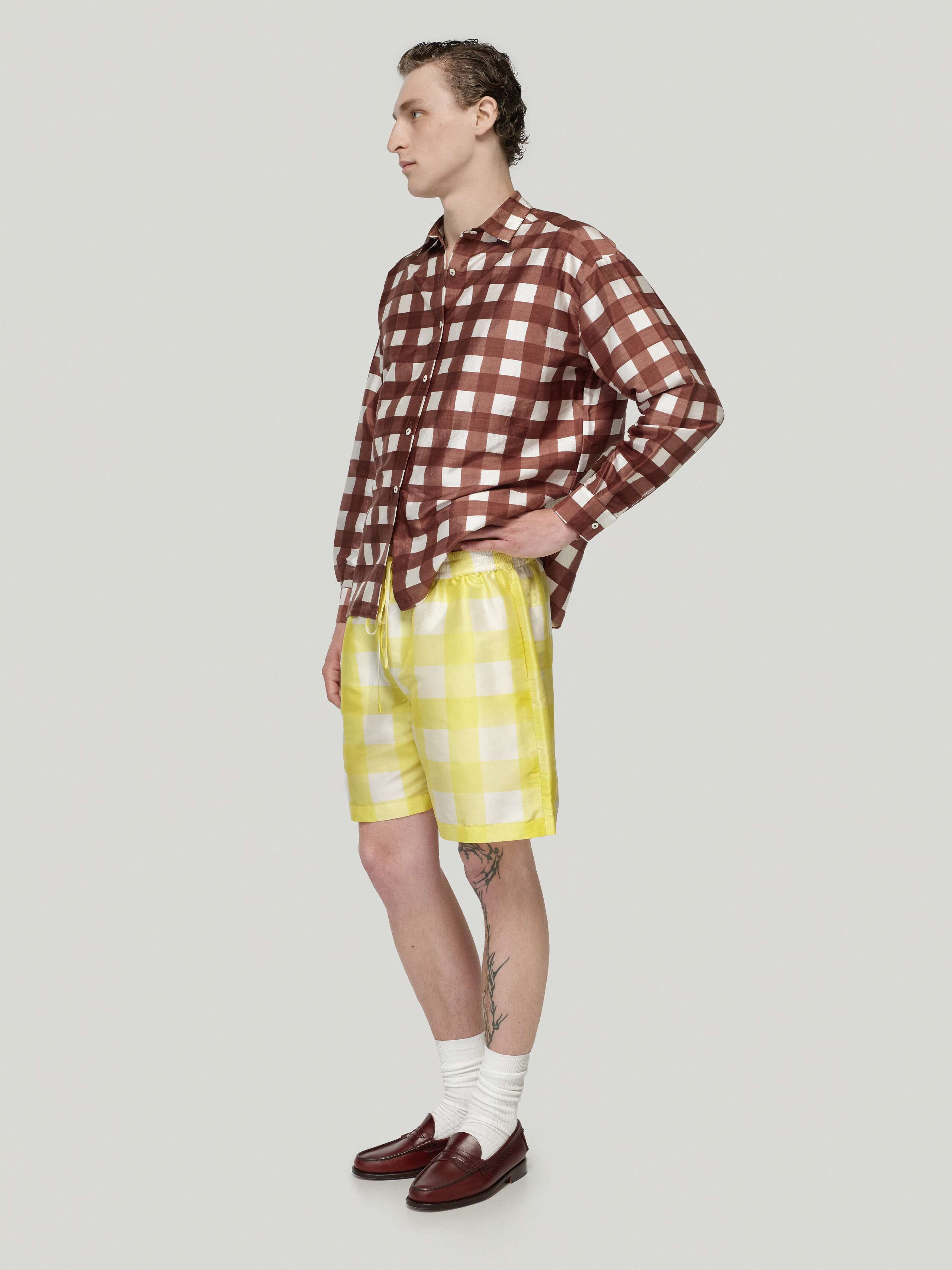 Male model wearing Francesca blouse in brown and allen shorts in yellow