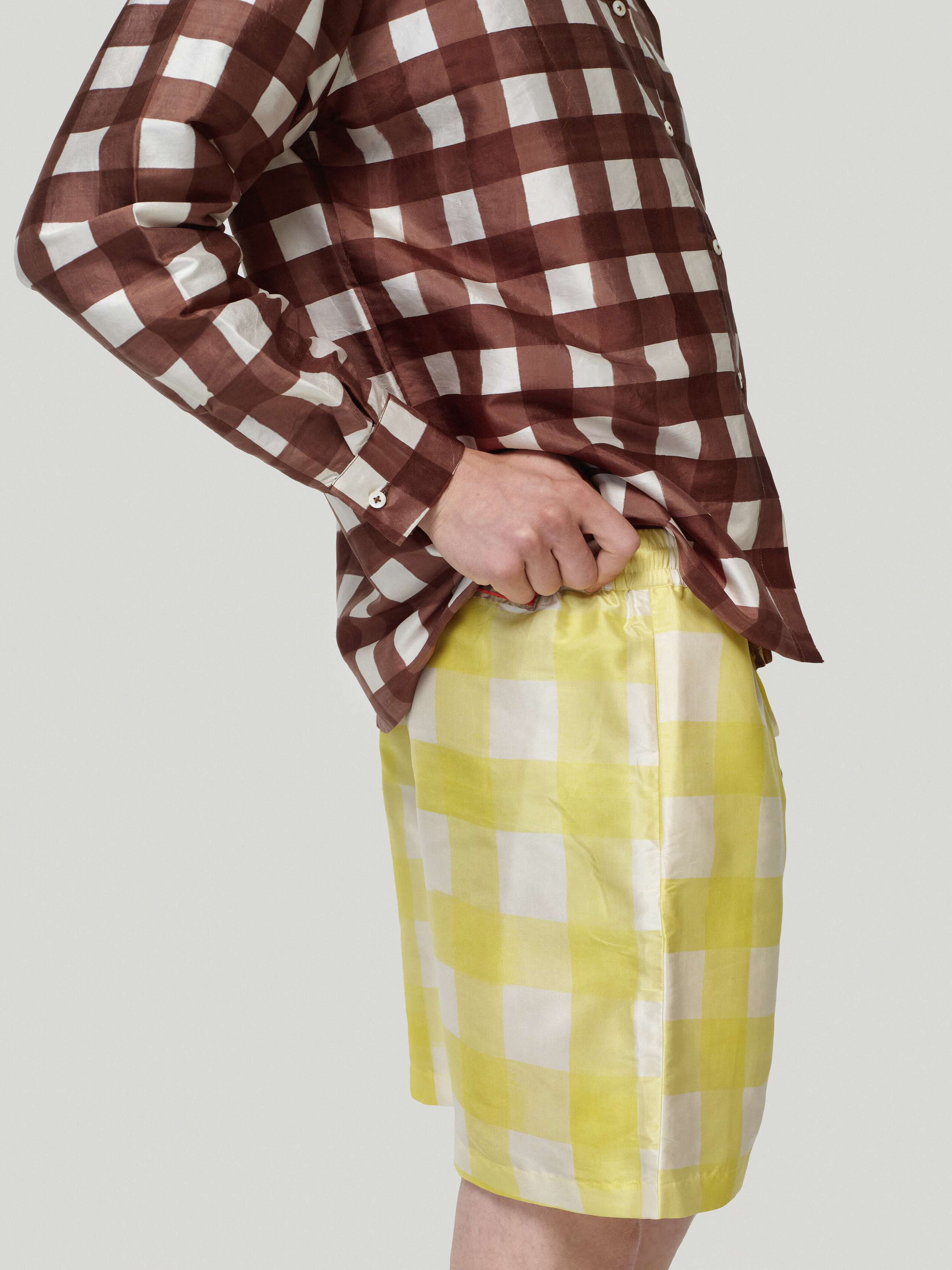 Male model wearing Francesca blouse in brown and allen shorts in yellow