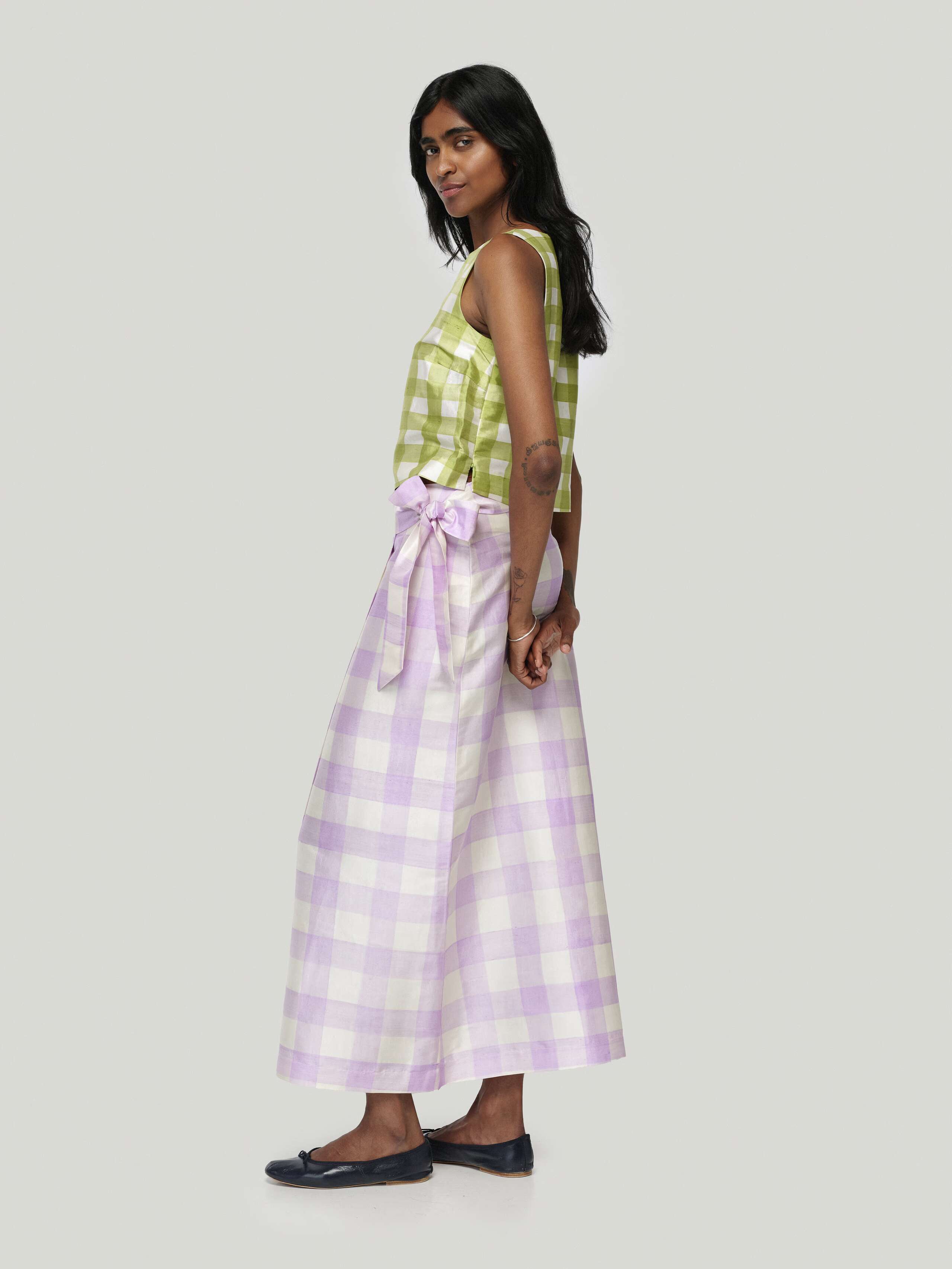 Model wearing edina long skirt handpainted vichy in lavender, combined with junko top in green