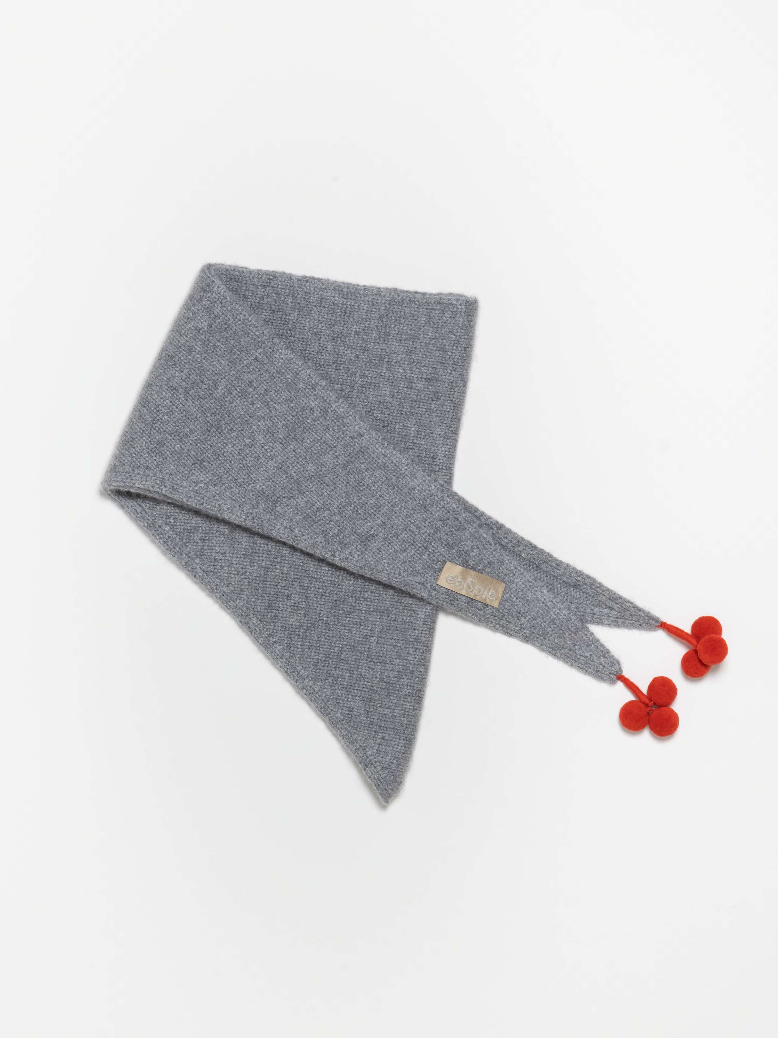 Detail Shot of Lula Triangle Scarf Pompon in Grey
