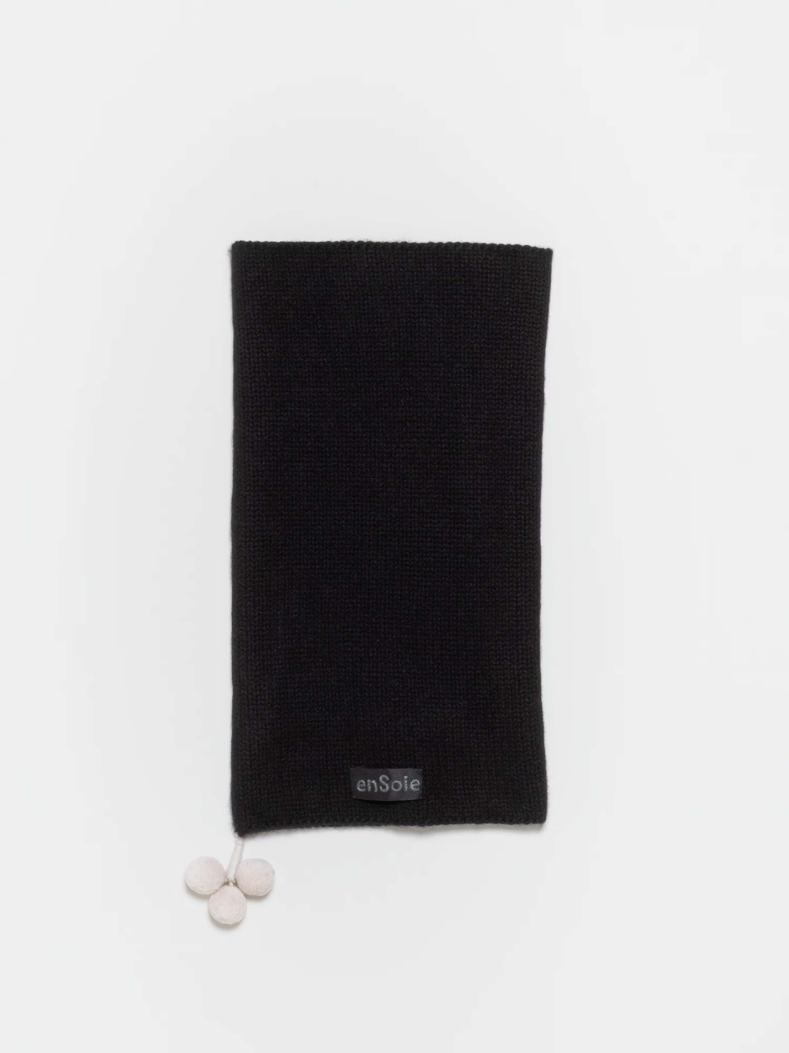 Detail Shot of Yul Tube Hat Pompons in Black