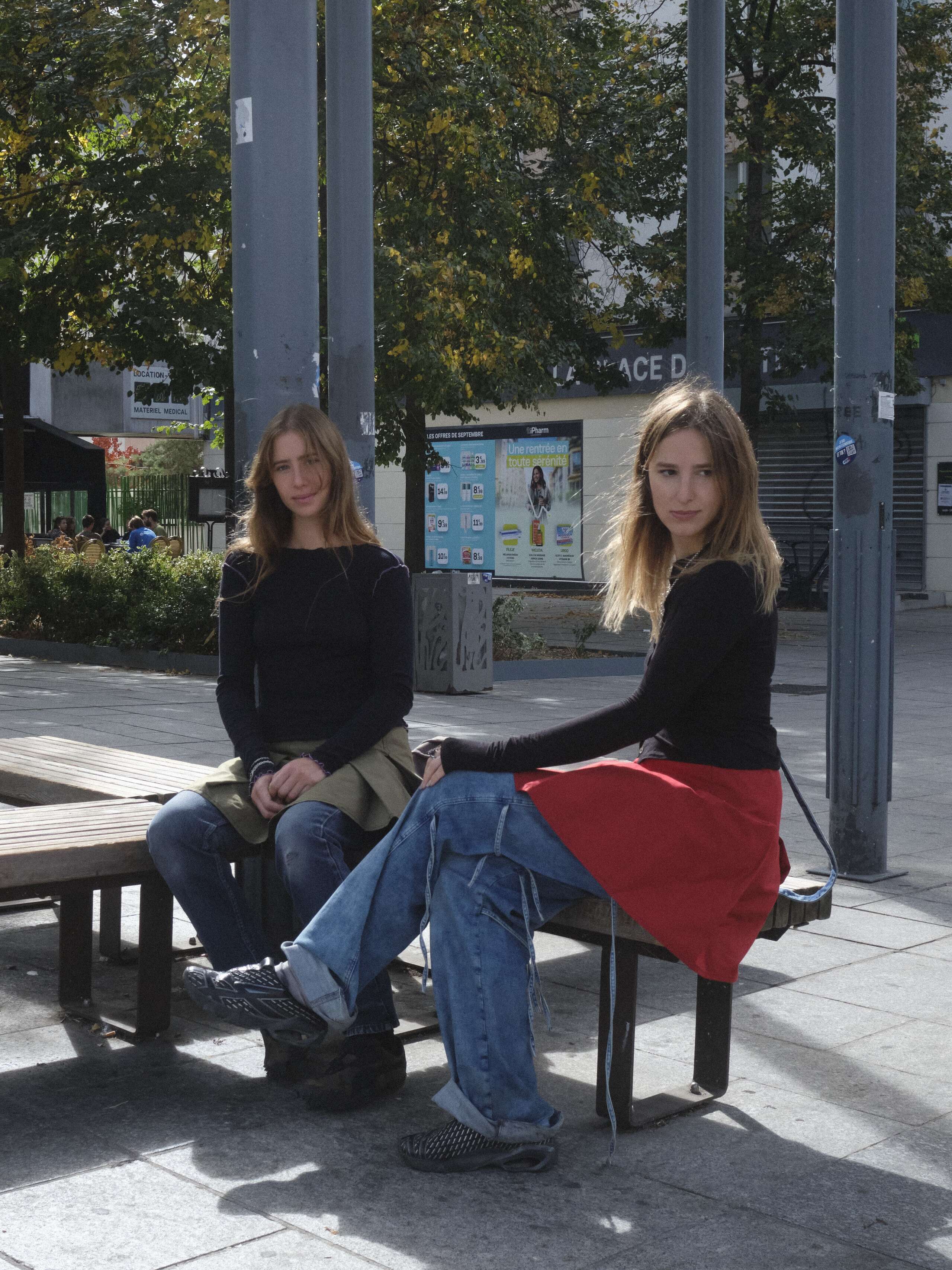 Two young women sitting in a park in Paris