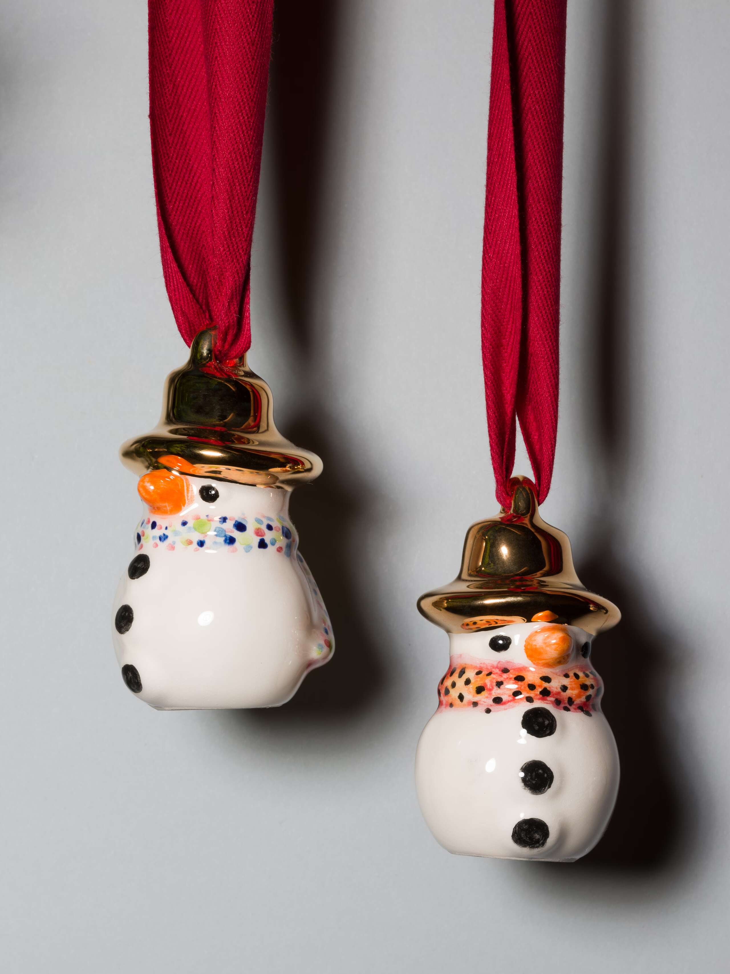 two cute little snowpal with golden hat and colourful scarf cute little snowpal ornament with golden hat and colourful scarf