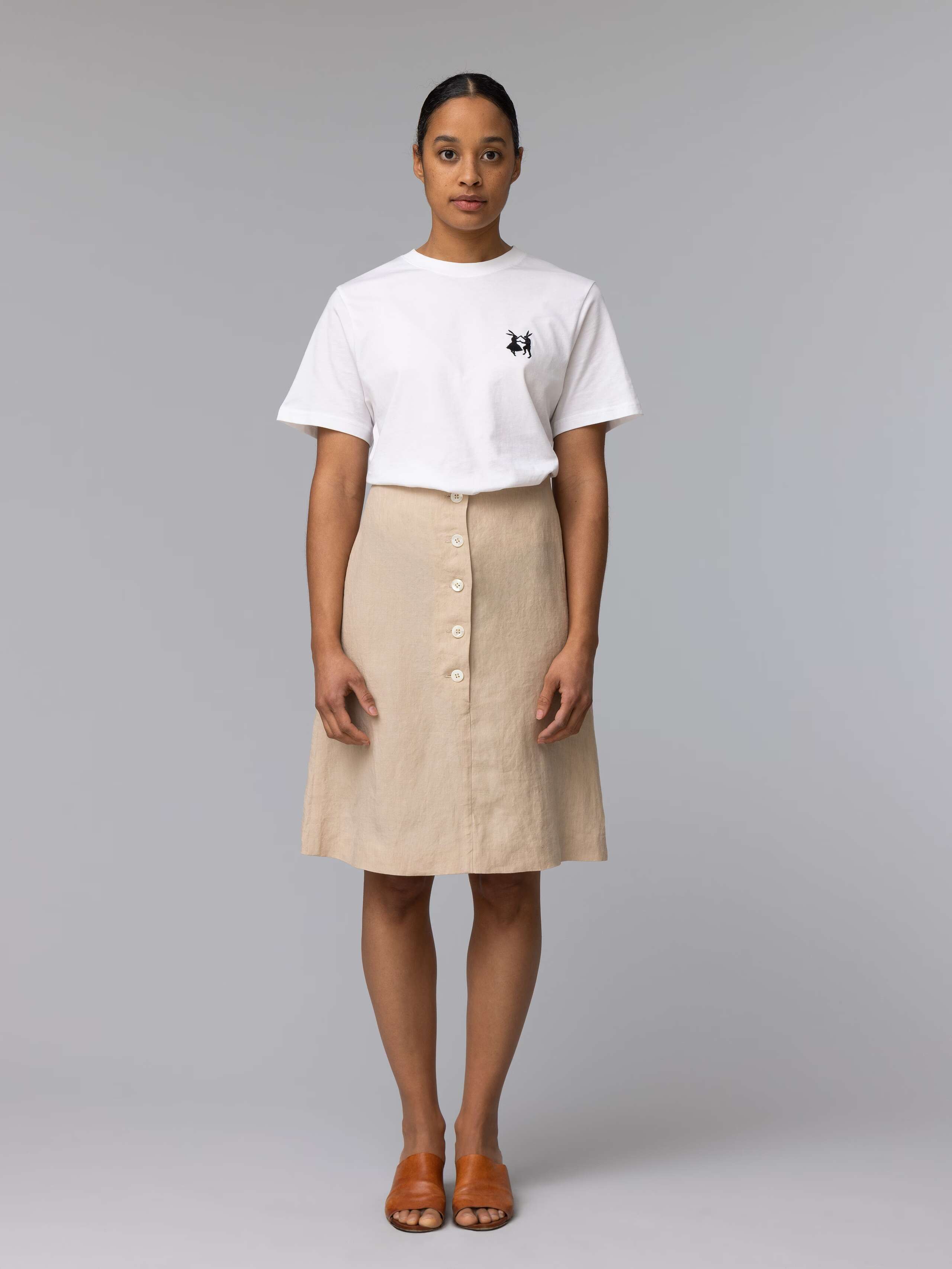 Model is wearing a beautiful beige linen skirt with nice mother of pearl buttons