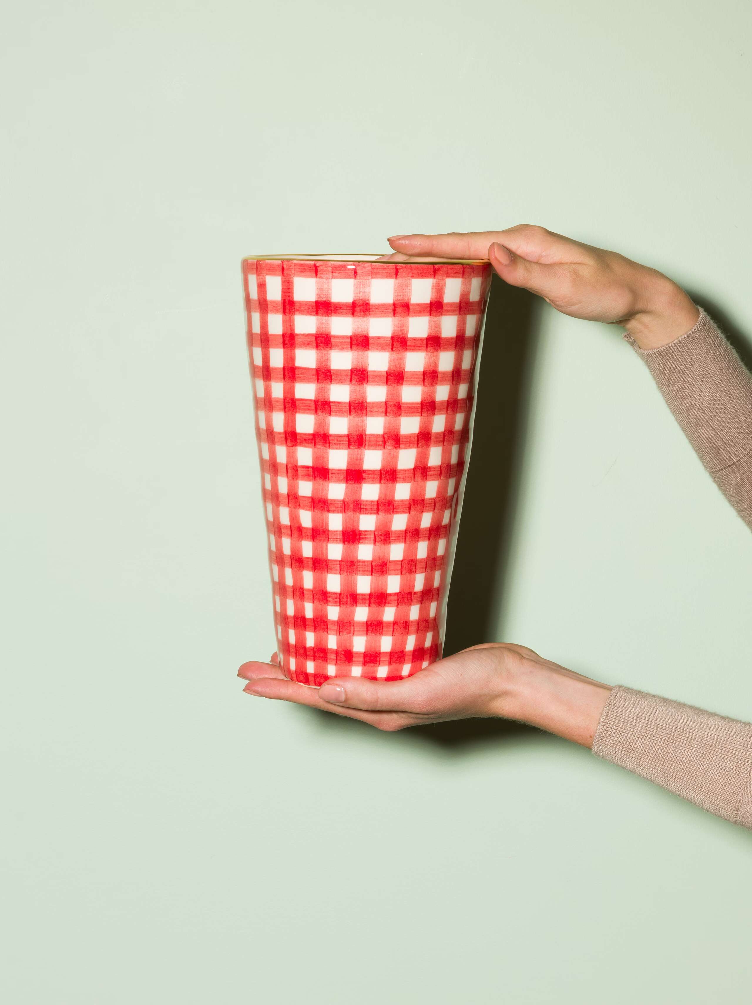 Picture of a handmade and handprinted big vase made of ceramic featuring a red vichy check pattern