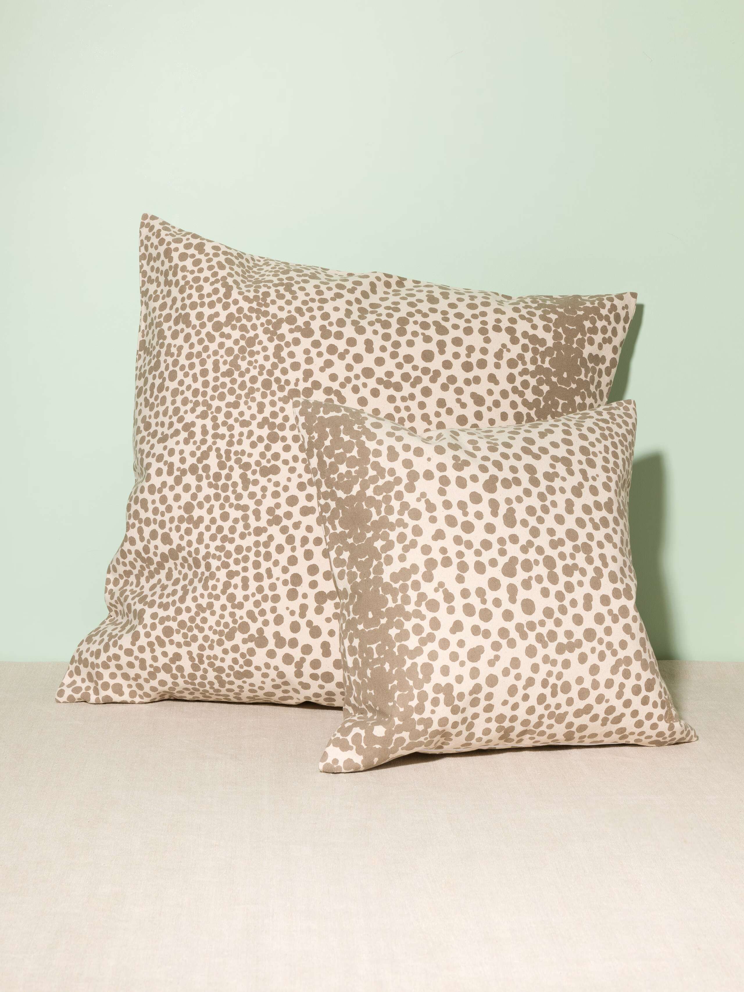 Picture of two pillow covers made from cotton canvas featuring beige dots
