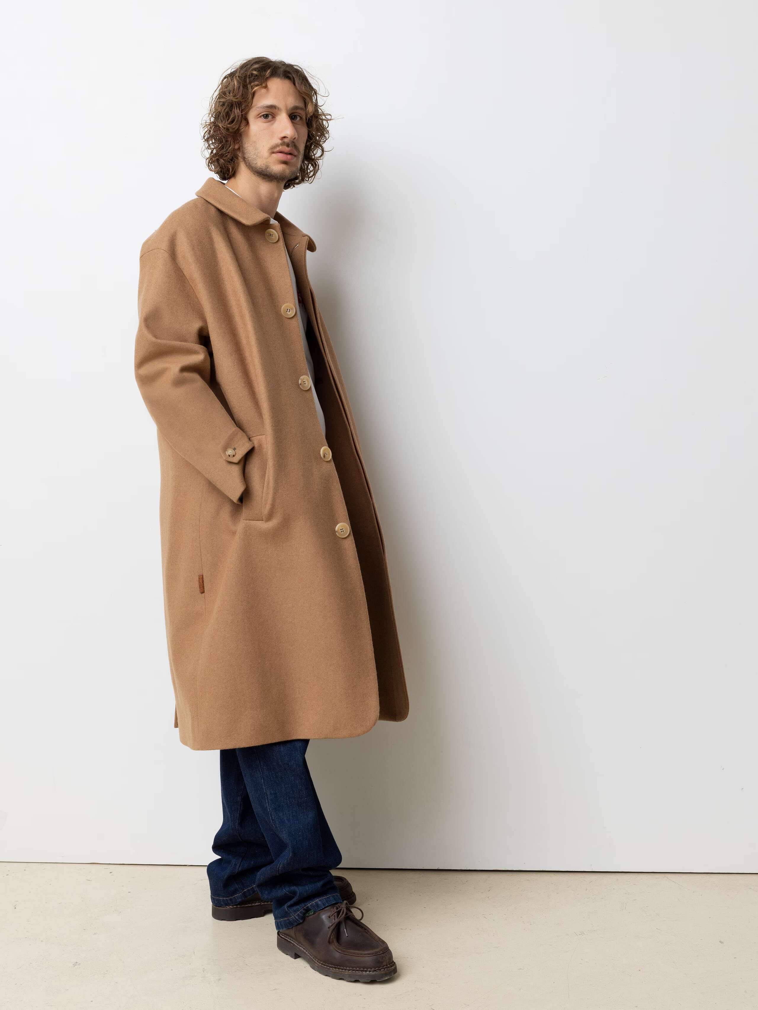 Picture of a male model wearing a beige loden wool coat