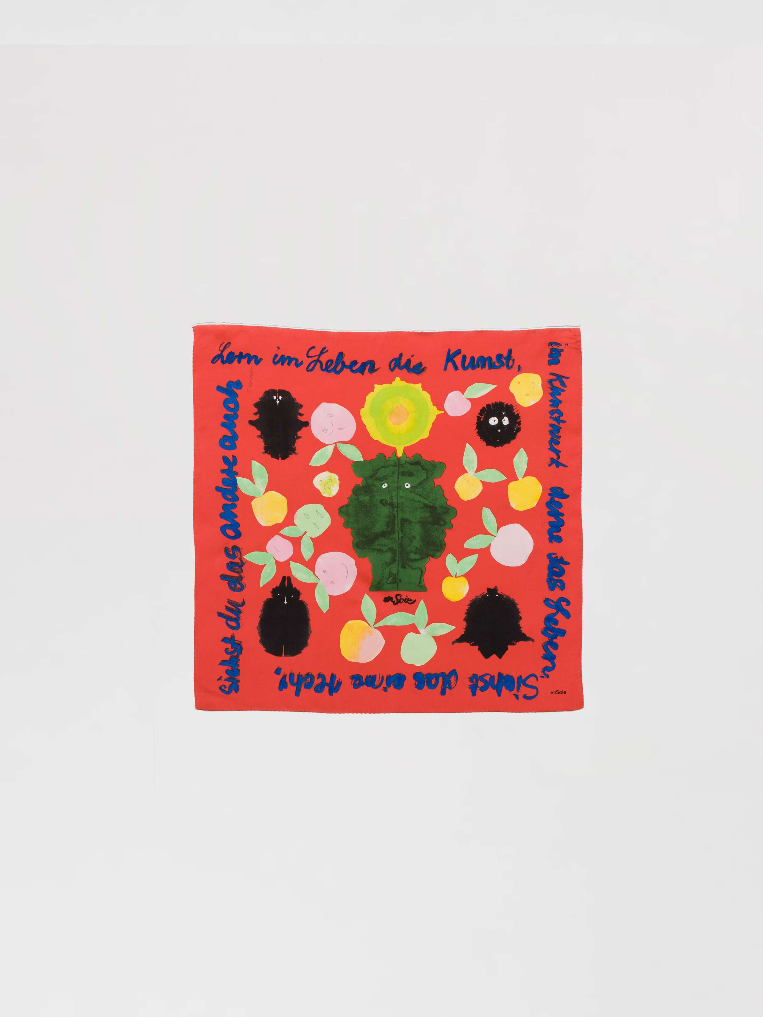 Picture of a bright orange red silk foulard featuring a colourful apple print