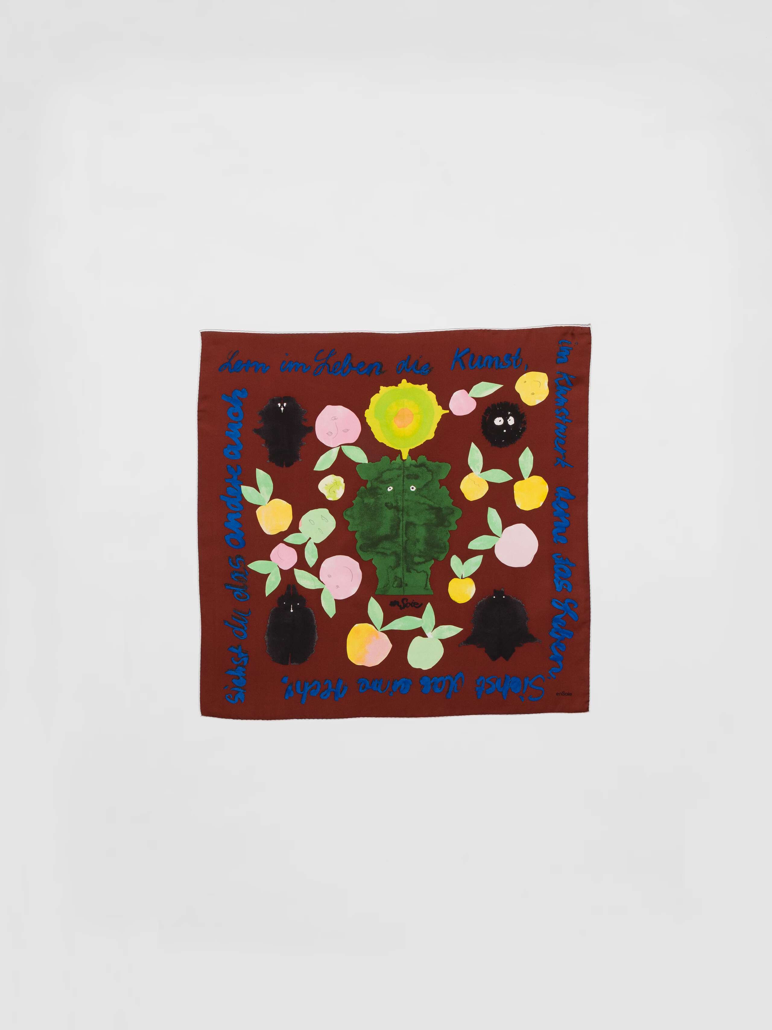 Picture of a brown silk foulard featuring a colourful apple print