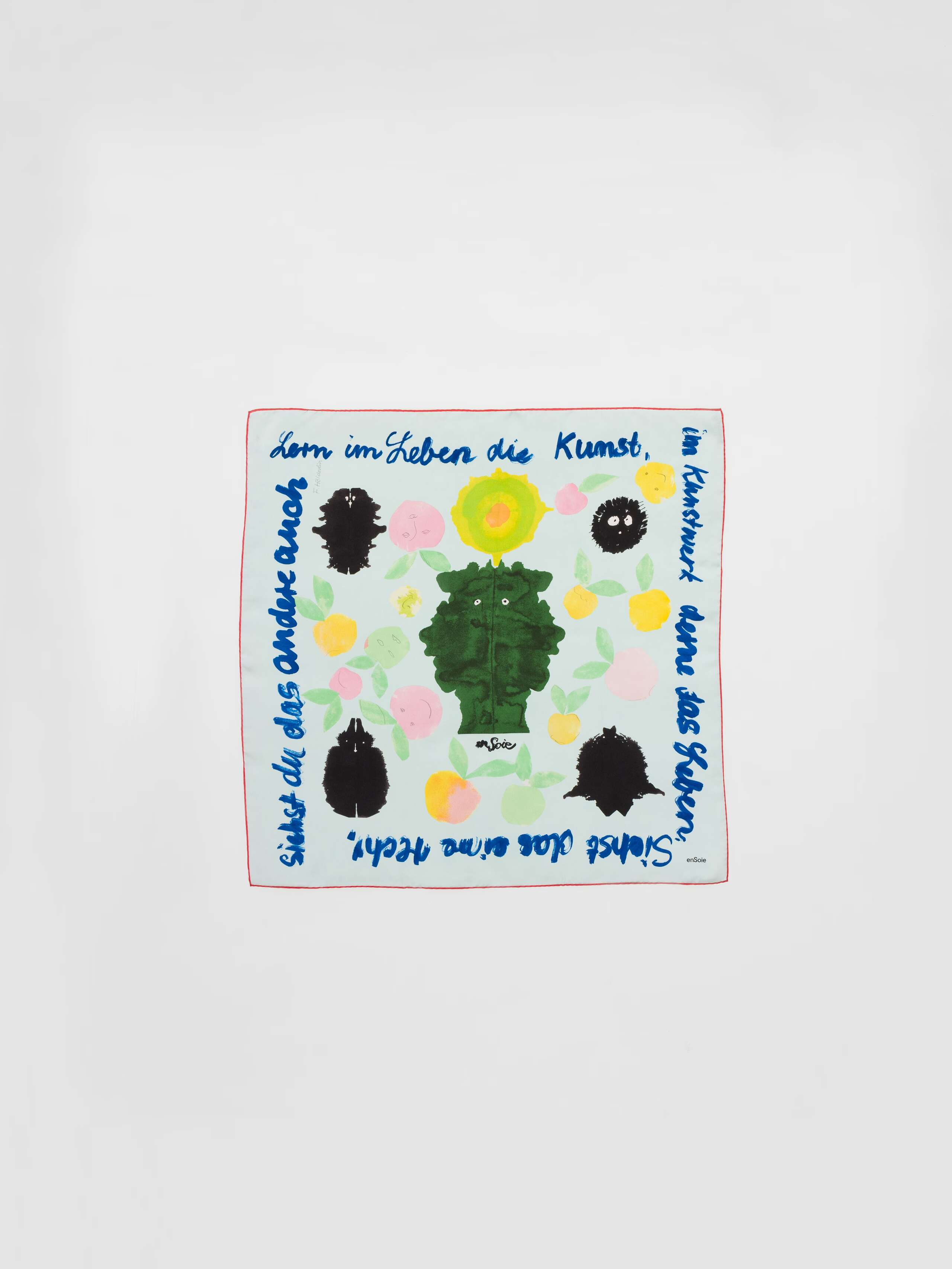 Picture of a light blue silk foulard featuring a colourful apple print