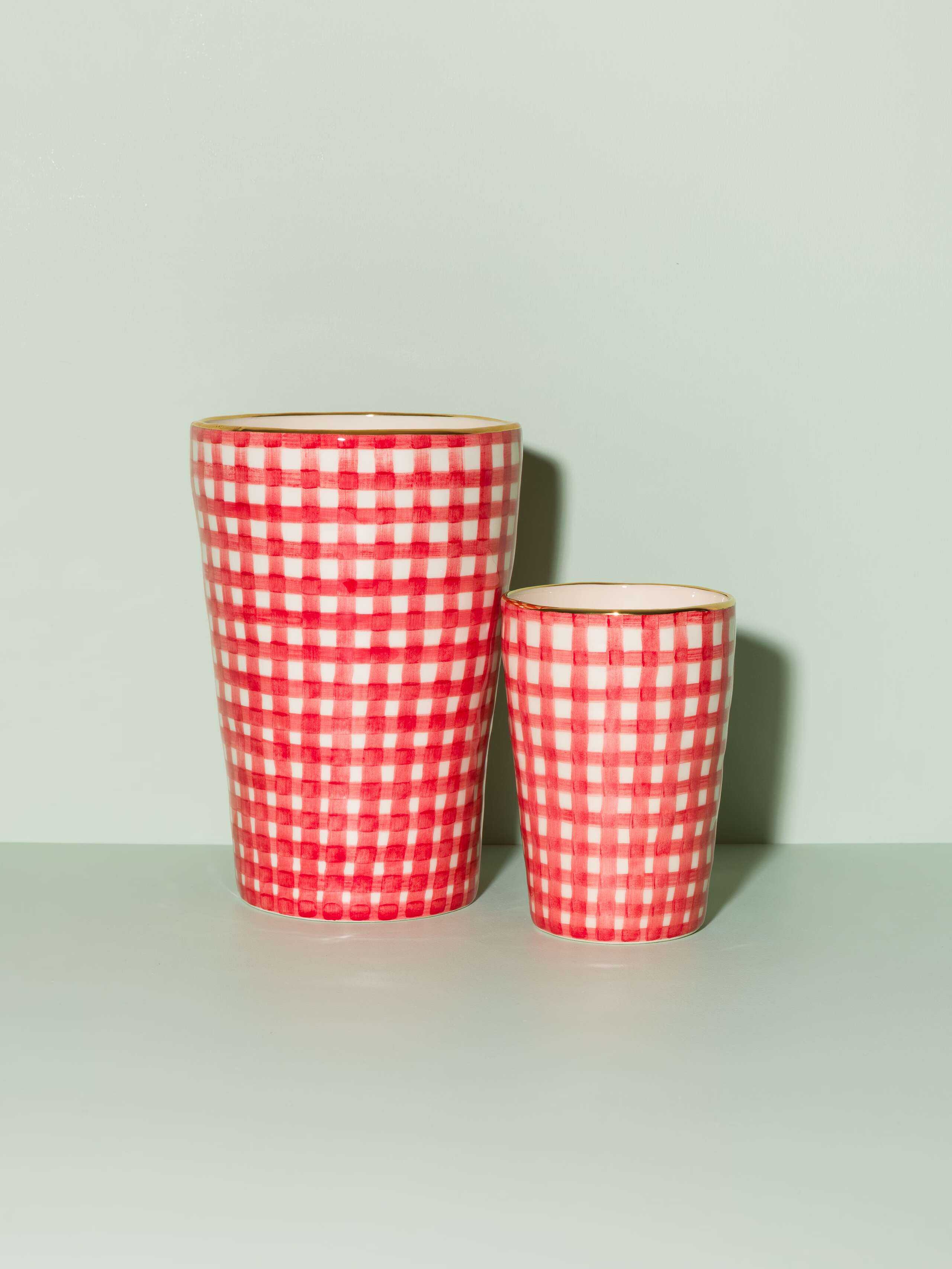 Picture of two vases featuring a red vichy check pattern