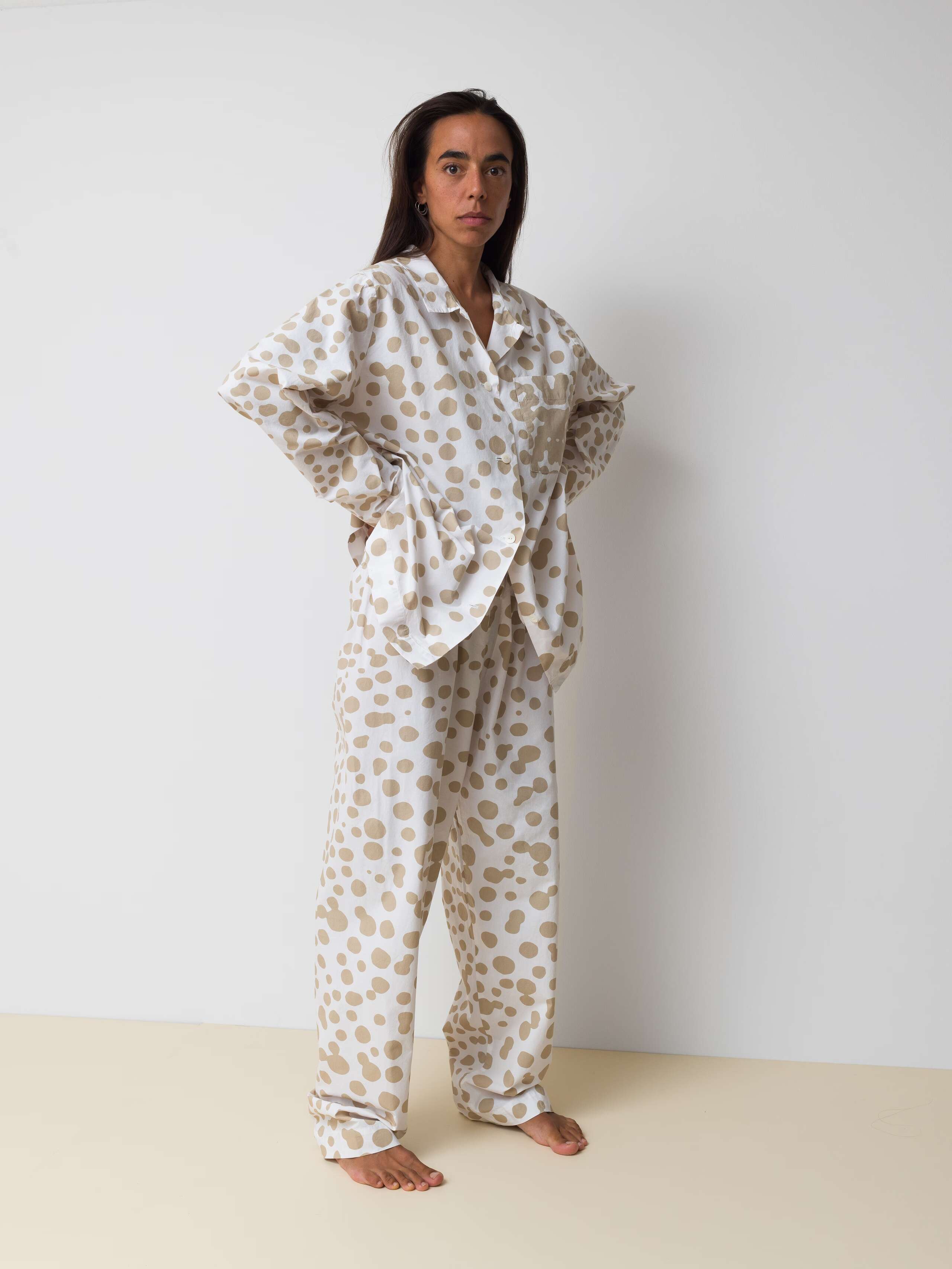 Picture of a women wearing a cotton pyjama featuring beige dots